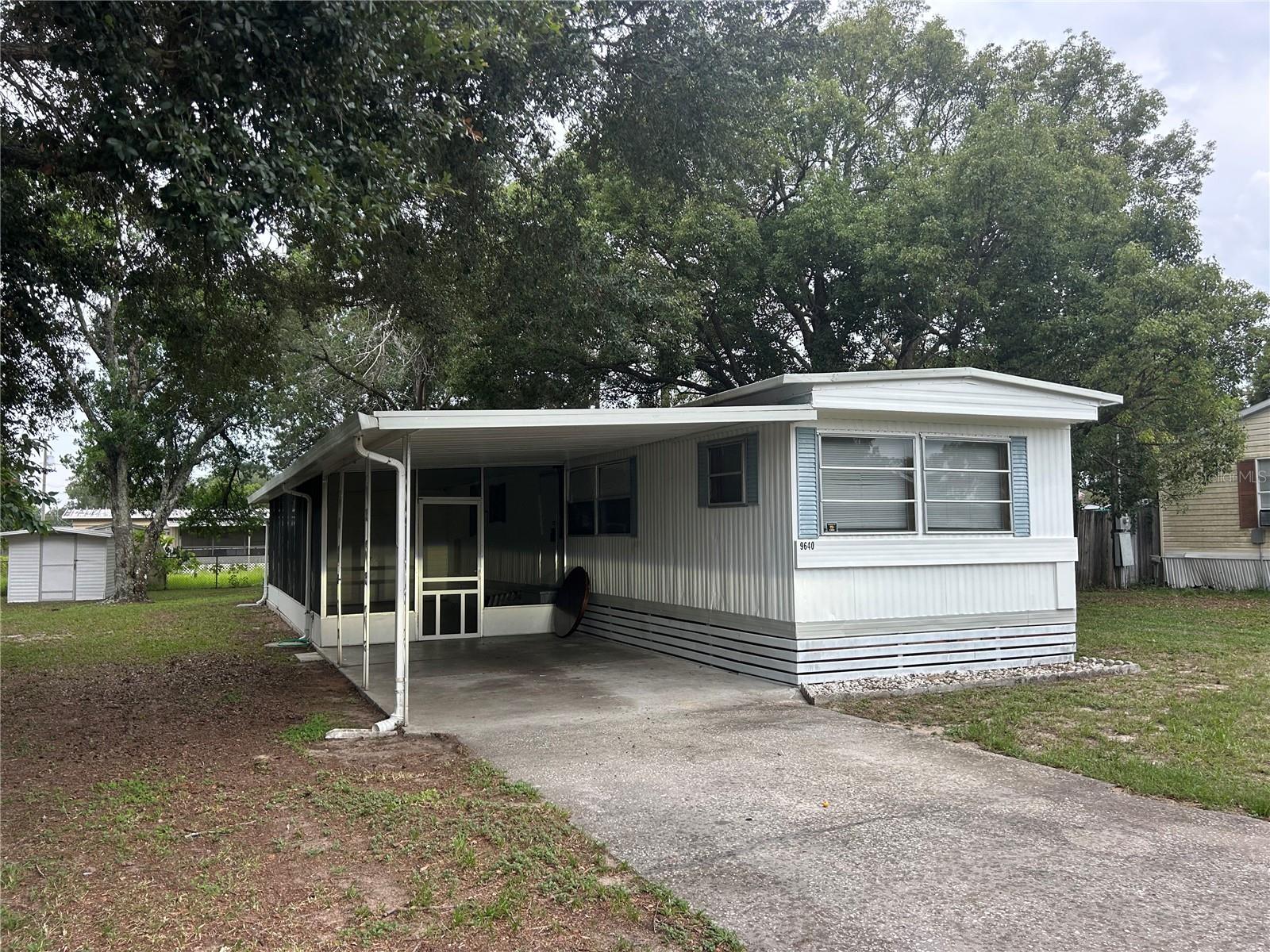 Affordable manufactured home in Summerfield! 2 bedrooms and 2 bath, open living and kitchen with eat in area, master bedroom has walk in shower and 2nd bath with tub/shower. New well pump and outside electrical service in 2025. 26x12 screen porch, 22x12 carport , 9x9 utility area with washer/dryer hookups and 6x8 storage shed. A great location that's close to The Villages for dining, shopping and entertainment.