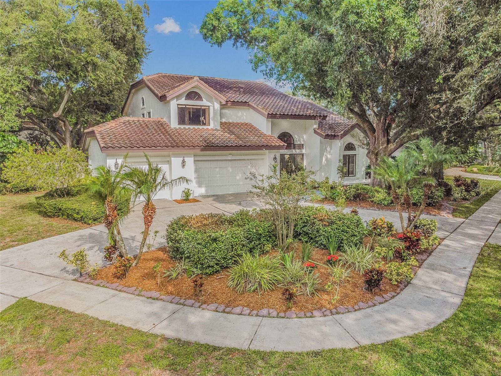 Elevate Your Living Experience in This Exquisite 4bd/3.5ba Retreat in the Highly Coveted Lake Magdalene Manors!

Prepare to be enchanted by the timeless beauty of this residence, boasting an array of recent enhancements that make it an exceptional find. The expansive family room beckons with its warm and inviting ambiance, featuring a wood-burning fireplace and tastefully crafted built-in bookshelves. The kitchen is a chef's dream, complete with granite countertops, stainless steel appliances, and custom-made wooden cabinets. Delight in your meals at the sizable granite breakfast bar or the built-in bar with a wine rack. Encased recessed lighting sets the perfect mood for any occasion.

Nestled on a expansive scenic water view corner lot, this residence boasts a sparkling pool and spa, as well as an outdoor kitchen that fulfills the ultimate entertainer's dream and separate full pool bath. The outdoor kitchen, equipped with granite countertops on a brick-paved lanai and a TV hookup, is the perfect setting for hosting gatherings while enjoying your favorite sports events. This home is laden with special features, from the striking front doors adorned with inlaid glass to the upgraded light fixtures and crown molding gracing every corner.

The grand foyer and elegant wooden staircase leading to the second floor, where all the bedrooms are situated, add a touch of grandeur to the home. Step through the impressive double doors into the Master Suite, a sanctuary that will leave you breathless. Granite countertops, plantation shutters, and a cozy fireplace set the tone for this extraordinary space. Your spacious Master suite includes a walk-out balcony/sundeck, and the Master Bath is a spa-like retreat with a large whirlpool tub, Roman Shower, granite His/Hers vanities, Grohe Brand fixtures, European Vessel Sinks, and His/Hers Walk-in closets.

Security is paramount, thanks to an in-home monitoring system with zone-to-zone surveillance. Other notable features include: New interior paint, refreshed landscaping, brand new light fixtures, 2022 AC units, water heater 2022, 2023 plush new upstairs carpeting, plantation shutters, irrigation system. 
The 3-car garage is not just for parking; it features a Dynamark plating finish, cable hookup, epoxy-coated flooring, and ample built-in cabinetry and workstations. Lake Magdalene Manors has an active community clubhouse, playground and tennis courts for residents.
Don't miss the opportunity to make this stunning gem in Carrollwood your forever home. Luxury living awaits! *VIRTUAL VIDEO AVAILABLE*