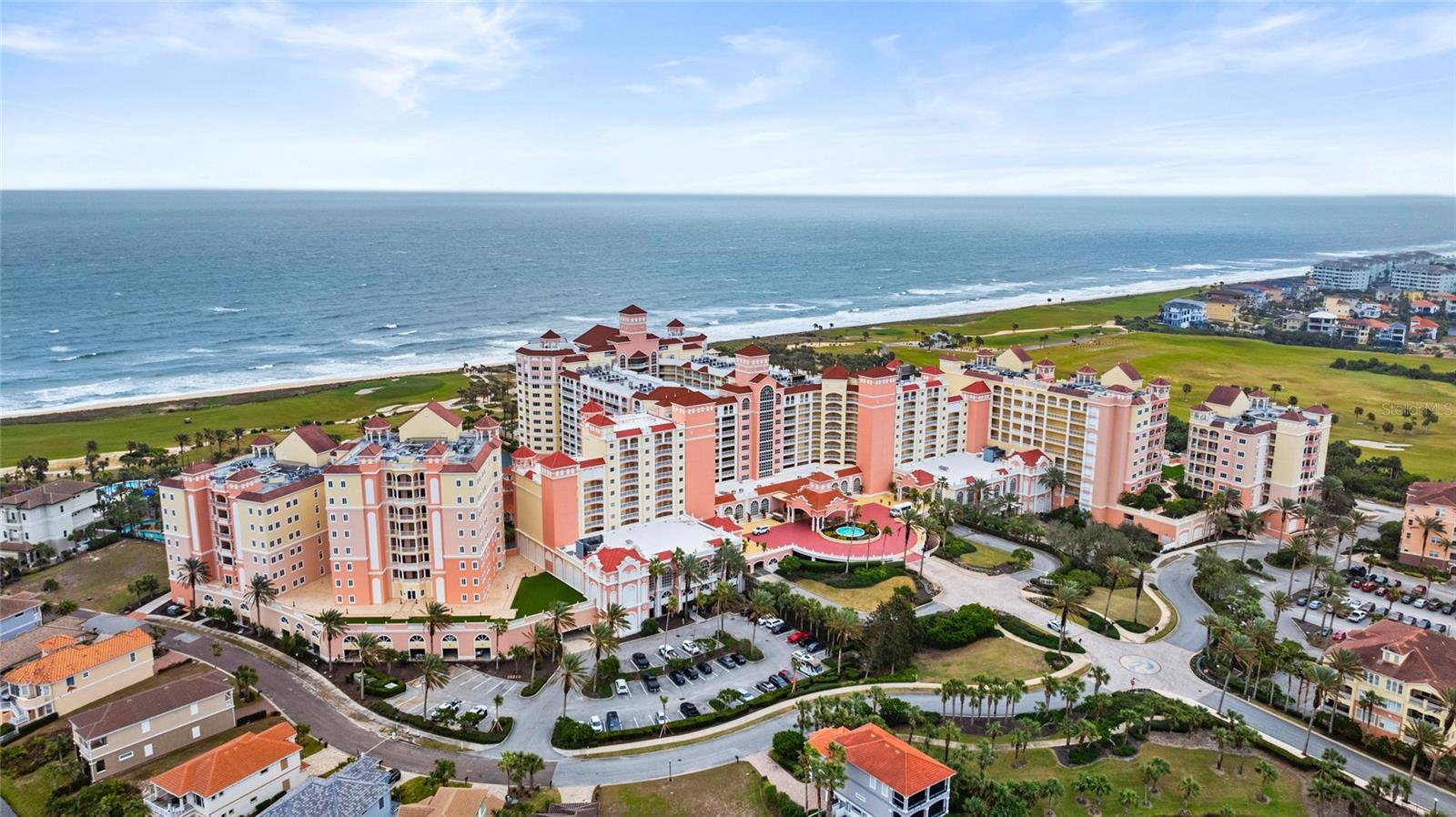 Welcome to a reimagined oceanfront MASTERPIECE — where no detail was spared & every corner echoes luxury. Overlooking the Atlantic Ocean in the Hammock Beach Club Resort, this 4 bedroom, 4 and 1/2 bath condo is a rare jewel: a full renovation to perfection, designed to elevate coastal living. As you enter, you're greeted by luxury vinyl plank floors, thoughtfully selected molding, and custom lighting. Architectural walls were reconfigured, columns removed and ambient LED lighting was added to sculpt both atmosphere and flow. Every door, knob, frame and hinge has been renewed to match the refined aesthetic. In the heart of the home, the kitchen is nothing short of showpiece-worthy: a fully reimagined layout with Wolf and Sub-Zero appliances, induction cooktop, integrated espresso and warming drawers and a sweeping quartz island along with stunning wood beams in the living room. Custom cabinetry was extended with a dedicated bar and candy/coffee area. A discreet, built-out walk-in pantry, complete with its own circuitry and built-in ironing system - ensures storage and utility marry elegance. Each bath is a sanctuary. Spanish inspired finishes, custom vanities, designer mirrors, frameless glass showers and built-in steam system in the primary bathroom invite indulgence. The primary suite shines with remote-controlled draperies, decorative wall detailing and sliders that beckon you onto your balcony. Linen closets now house precision wood shelving. The condo also boasts a dedicated office, custom drapes, remote blinds and built-in automation. Outside, the balcony frames sweeping Atlantic Ocean views, letting in sea breezes and sunset light. As part of the Hammock Beach Club, your ownership and an optional membership unlocks access to world-class amenities: championship golf designed by Jack Nicklaus & Tom Watson, resort-style pools, a spa, fitness center, tennis and pickleball courts, exquisite dining and oceanfront experiences that rival a private resort. This is not just a property—it’s a statement. A work of art where architecture, design and locale converge. For buyers who pursue perfection, this is your opportunity. Schedule your private preview today and step into a lifestyle redefined.