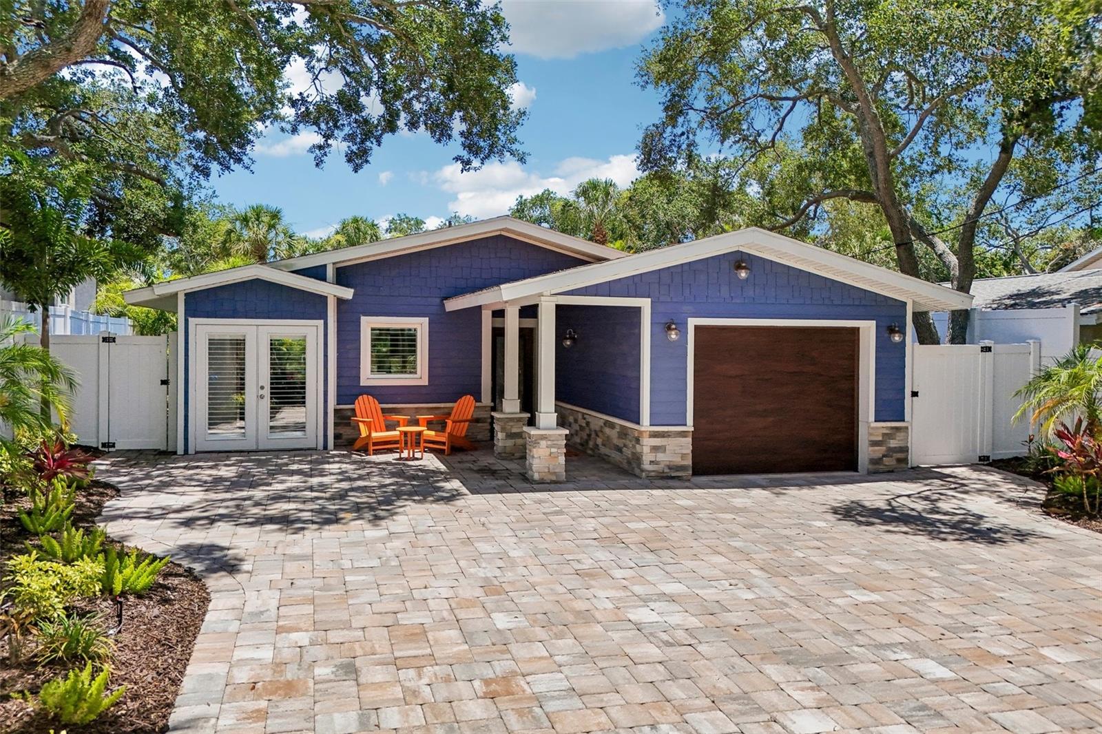 Your island escape awaits!  Masterfully renovated and beautifully styled, this turnkey-furnished and move-in ready 2-bedroom, 2-bathroom, 1-car garage pool/spa coastal residence offers an unmatched island lifestyle on Siesta Key. Positioned on a tranquil residential street, this beautiful home sits at the intersection of privacy and prestige—just moments from the culinary delights of Siesta Village and the iconic white Quartz sands of Siesta Beach. The interior design embraces a bright, open floor plan defined by a sophisticated coastal color palette and seamless indoor-outdoor integration. At the heart of the home is the gourmet kitchen, featuring premium Cambria quartz countertops, classic farmhouse sink, and luxurious Wolf and Sub-Zero appliances. Thoughtful details include subway tile backsplash, a convenient pot filler, and custom soft-close cabinetry. Retreat to the primary bedroom suite, featuring a custom walk-in closet and an elegantly appointed en-suite bath with a granite-topped double-sink vanity and a beautifully tiled walk-in shower. Guests will enjoy total privacy in the secondary bedroom and guest bath with shower over tub. Outside, the screened lanai functions as an outdoor living room, offering views of the heated saltwater pool, integrated spa, and manicured tropical grounds, lovely in the evenings with custom outdoor lighting. Every detail has been upgraded for maximum comfort and durability, from the impact-glass windows and doors to plank tile flooring throughout, new laundry room with front-load Samsung washer & dryer and a high-efficiency tankless water heater. Boasting a proven location with income potential exceeding $100,000 per year, this property represents a rare opportunity as an excellent investment or your ideal seasonal or permanent home. No HOA! Schedule your showing today!