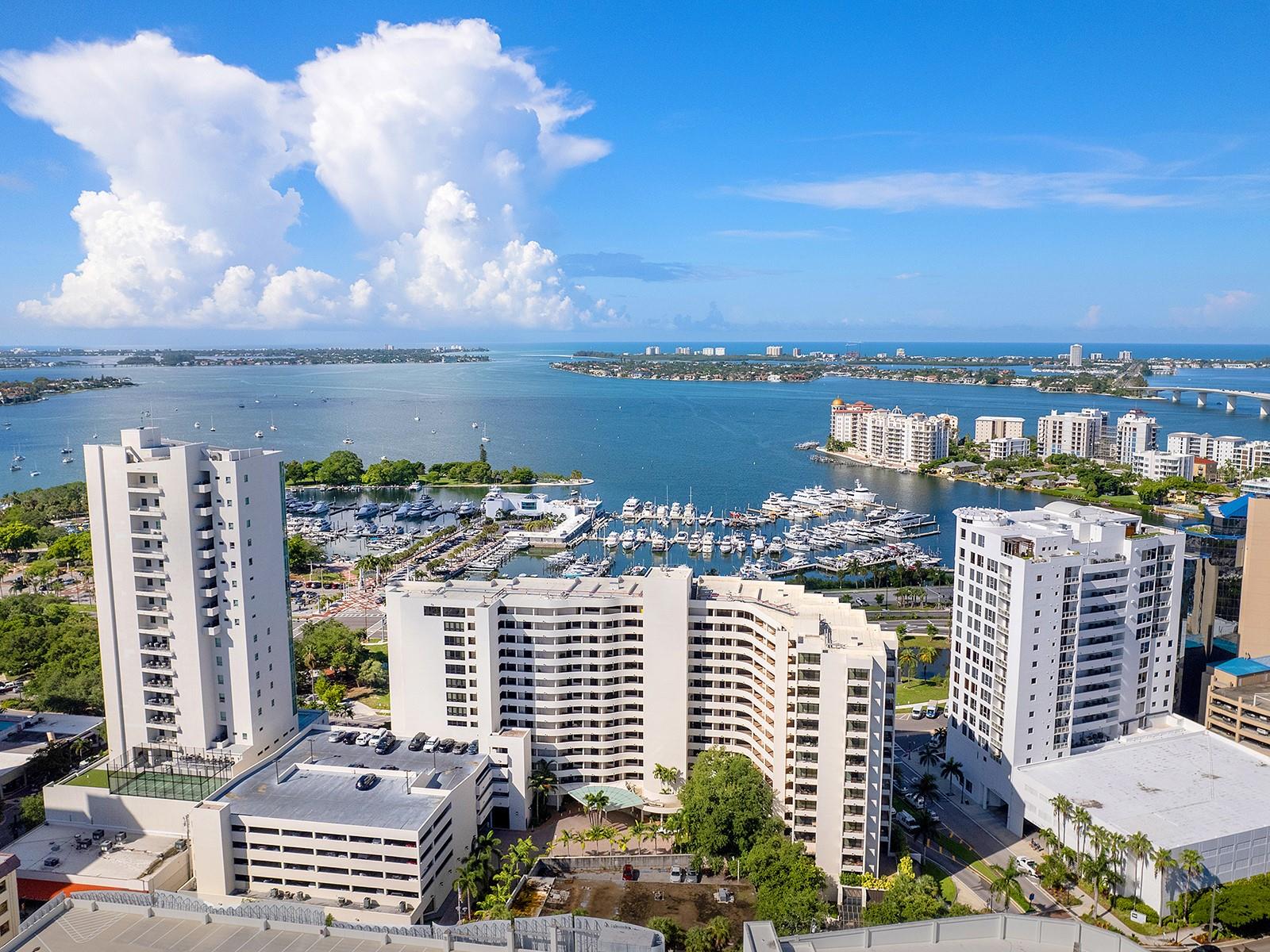 One or more photo(s) has been virtually staged. Refined downtown living awaits at Bay Plaza, a premier address along Gulfstream Avenue and one of Sarasota's most established and distinguished buildings — designed by the celebrated architect Tim Siebert. This exceptional second-floor residence offers something increasingly rare in urban living: a genuine connection to nature and neighborhood, with tree-lined street views below and partial marina glimpses that shift beautifully with the light and seasons.
Perfectly positioned, this is a home that places you at the center of Sarasota's most vibrant cultural tapestry — steps from fabulous restaurants, the iconic Opera House, art galleries, charming coffee shops, live theatre, boutique shopping, and the beloved Saturday morning Farmer's Market. Yet despite this enviable proximity, the residence itself feels like a quiet retreat, grounded and peaceful above the gentle rhythm of the street.
The well-executed split floor plan creates a natural sense of privacy and balance, with thoughtfully separated bedroom suites ideal for both full-time living and hosting guests. The living and dining areas are designed for effortless entertaining and everyday comfort, while a crisp, light-filled interior aesthetic is elevated by natural light and a seamless flow leading to a private covered balcony. Impact-resistant glass throughout the residence enhances safety and peace of mind, allowing you to enjoy the natural light and views with confidence. The kitchen anchors the living space with a practical and functional layout, offering considerable storage and a wine and beverage refrigerator — a thoughtful touch for those who love to entertain.
The primary suite is a peaceful sanctuary, framed by large picture windows that sit among the treetops, filling the space with natural light and a serene connection to nature and the water. A generous walk-in closet with custom built-ins provides organization and ample storage. The en-suite bath is thoughtfully appointed with wood cabinetry, dual sinks, and granite countertops, complete with a soaking tub and separate shower.
Bay Plaza residents enjoy a full-service lifestyle that is second to none — including 24-hour concierge, 24/7 valet service, EV charging stations, a resort-style pool and spa, and a state-of-the-art fitness center complete with sauna and steam room. The beautifully appointed lobby — a hallmark of Siebert's vision — showcases a grand piano, a library and media room, and elegant entertaining spaces for gathering with friends and fellow residents.
This is a rare opportunity to own a home that offers timeless appeal, privacy, and effortless access to everything that makes Sarasota one of Florida's most coveted destinations. One or more photos has been virtually staged.