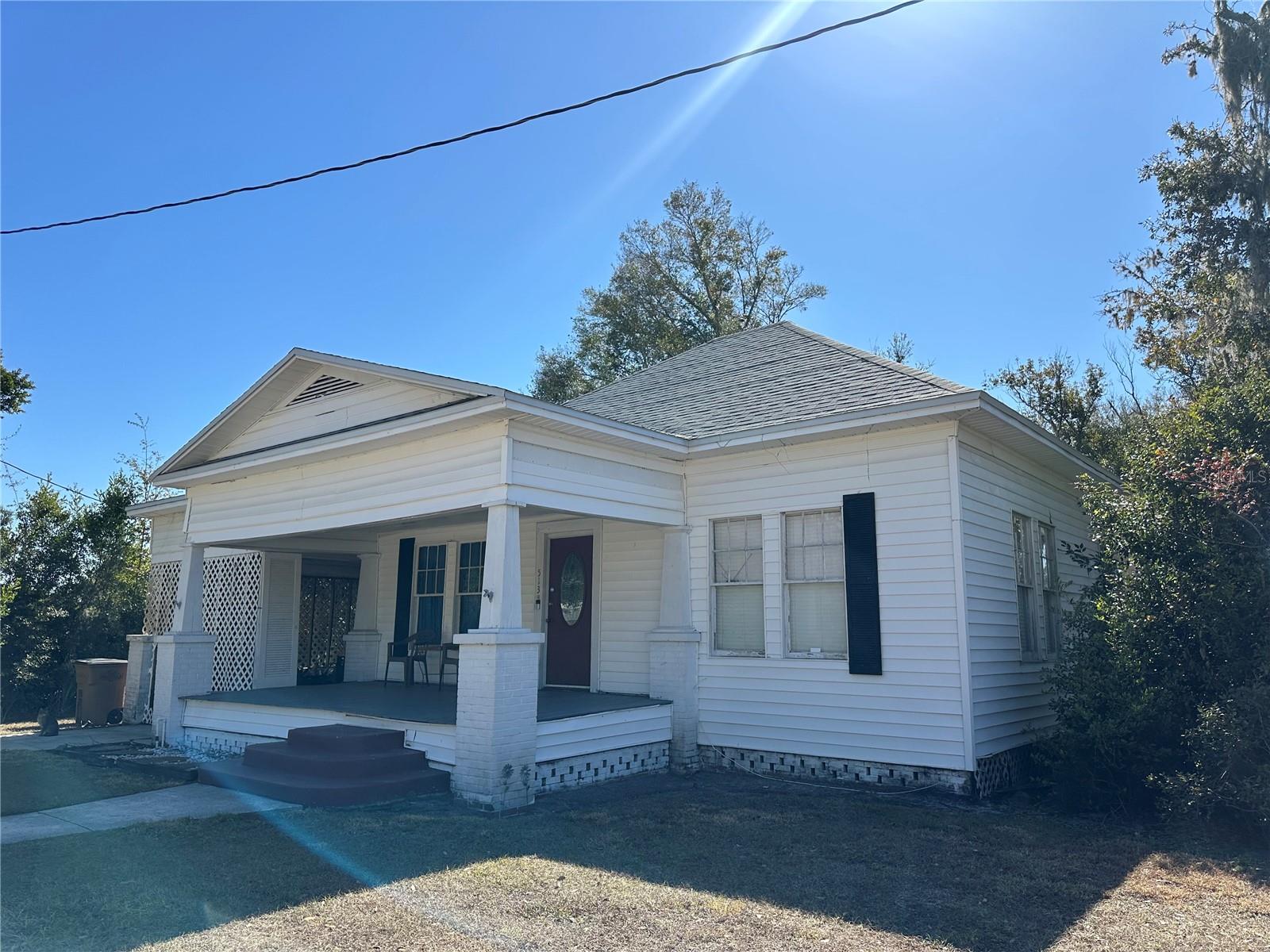 PRICE REDUCTION!  Check out this 4/3 bath Historic Home built in 1915 and located in the Historic District of downtown Wauchula on almost a half-acre. The property was nominated in 2018 to be registered with the National Register of Historic Places in the State of Florida.  With a little TLC, some fresh paint and a loving owner this historic home can be brought back to life and again become the jewel of the community. Bring the hardwood floors back to a beautiful life.  Breaker box has been updated and the home passed a 4-point inspection for insurance a few years ago. It has a current termite contract. A 200 amp 9500 watt Generator stays with the house for any unpredictable weather alerts. The washer/dryer/ Whirlpool range and fridge are approximately 4 years old.  The newly shingled hip roof was put on 2022. A concrete slab covers the back side of the large lot for Motor home parking, put up fencing for pets (part of the yard already fenced) , play area, entertaining. A front porch and side patios are ready for outdoor enjoyment. The spacious kitchen has adjoining room that can be used as a work area for your hobbies, a media room, library, office, study, den or an inventory space for those extra orders.  Choose what you need for extra space because there is also an adjoining dining room on the other side. The back area has a separate entrance and could be used for a Mother-in-law quarter or giving privacy for your overnight guest. The community of Wauchula is approximately 90 minutes from the beaches in Bradenton/Sarasota, Ft Myers, Tampa/St Pete Airports, and from the theme parks in Orlando.  This property is on Main Street and possibilities for rezoning to Commercial for a small business or remodeled for a Bed & Breakfast.
