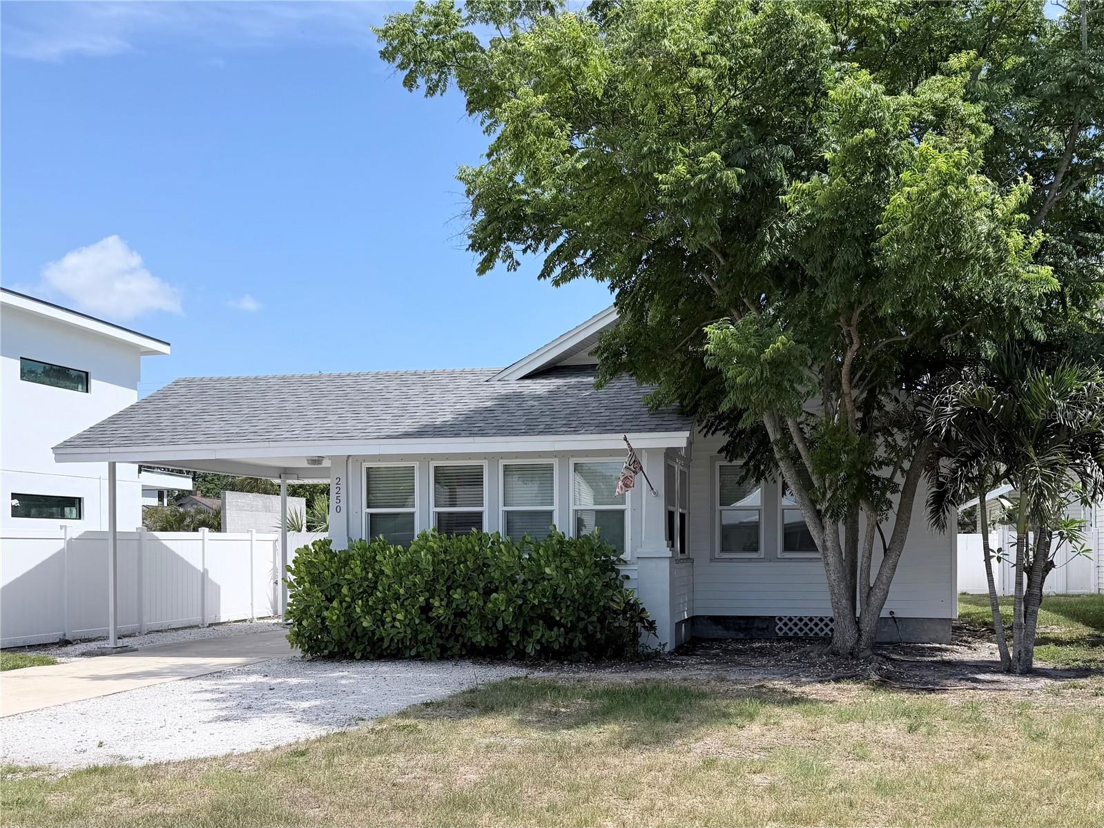 Charming Key West–style bungalow in the highly desirable Arlington Park neighborhood. Beautifully updated while maintaining original character, including hardwood floors, glass doorknobs, and detailed trim. Flexible floor plan with two potential primary suites, each with en suite baths.

The light and bright kitchen features stone countertops, stainless range hood, bar seating, and a secondary sink area ideal for a wet bar. Multiple living spaces include a family room with decorative fireplace, a sun-filled Florida room perfect for an office or reading space, and a versatile bonus room for a gym, playroom, or additional workspace. Formal dining room and ample storage add to the functionality.
Exterior features include a carport, extended driveway with room for a boat or golf cart, and a large fenced backyard. Separate storage/workshop space with built-ins provides additional flexibility.

Ideally located just steps from Arlington Park with walking trails, pool, tennis courts, playground, and dog park. Minutes to Sarasota Memorial Hospital, downtown Sarasota, and Siesta Key. A perfect primary home, vacation retreat, or investment opportunity in one of Sarasota’s most sought-after areas.