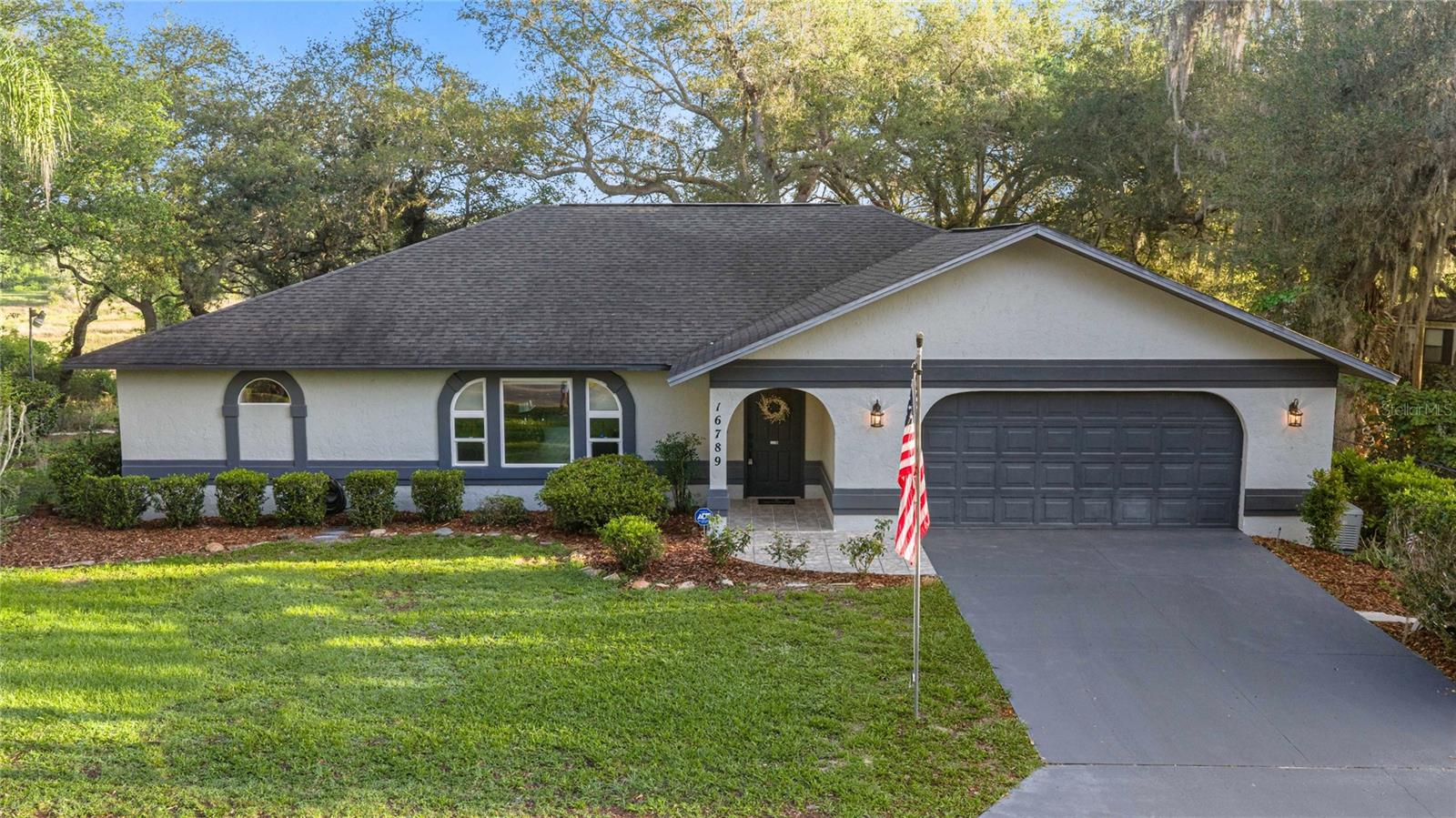 One or more photo(s) has been virtually staged. Discover peaceful Florida living at 16789 SE 69th Lane, Ocklawaha, FL—a beautifully updated 3-bedroom, 2-bath home nestled on a spacious .62-acre homesite with breathtaking panoramic pond views and a true nature-inspired setting. From the moment you arrive, you’ll notice the tranquility that surrounds this property, where mature trees, abundant wildlife, and picturesque scenery create a private retreat feel. Inside, this move-in-ready home offers 2,106 square feet of thoughtfully designed living space featuring brand-new luxury vinyl flooring throughout, fresh interior paint, updated lighting fixtures, granite countertops, matching Whirlpool appliances including a new refrigerator, and a striking stacked-stone fireplace that anchors the living area with warmth and character. The enclosed Florida room under air provides the perfect sanctuary to sip morning coffee, birdwatch, and enjoy the ever-changing natural beauty just outside your windows. Outdoors, the adjacent double lot creates a park-like atmosphere ideal for enjoying open space and peaceful surroundings. Practical upgrades include a generator with two owned gas tanks, humidity-controlled A/C system (2018), roof (2017), hot water heater (2016), plus two storage sheds measuring 9x13 and 12x15 for hobbies and equipment. Located in Ocklawaha, a destination known for outdoor recreation and natural beauty, residents enjoy convenient access to Lake Weir, Carney Island Recreation & Conservation Area, and the world-famous Silver Springs State Park offering kayaking, boating, hiking, fishing, trails, wildlife viewing, and endless opportunities for outdoor adventure. Whether you’re searching for a serene escape, a nature lover’s paradise, or simply room to enjoy the beauty of Central Florida, this Ocklawaha gem offers a lifestyle worth experiencing.