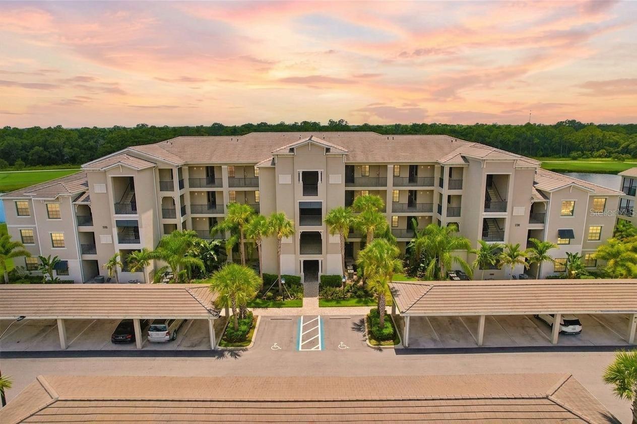 Escape to your own slice of paradise in this beautifully appointed condo set within one of Florida's most sought-after resort-style golf communities. Whether you're after a personal retreat, seasonal escape, or turnkey vacation rental, this residence offers the rare blend of comfort, style, and flexibility, with room to add your own personal touches and make it truly yours. Can be sold turn- key furnished for added convenience and an effortless move in experience. Step inside to a bright, open-concept living and dining space filled with natural light. Large-format tile flooring runs throughout for easy care and a clean, coastal feel, while crown molding and a soft palette of whites and seafoam blues set a polished but relaxed tone. The main living area opens to a screened lanai through floor-to-ceiling sliding glass doors, framing serene lake and golf course views that make for peaceful Florida mornings and evenings alike. The updated kitchen pairs function with style: crisp white shaker cabinetry, quartz countertops, GE stainless steel appliances, and a center island with a double basin sink, pendant lighting, and breakfast bar seating for four. Crystal-style pendants add a touch of sparkle, and a separate dining area anchored by a coordinating chandelier offers a more formal setting when guests are over. The condo offers 3 bedrooms and 2 full bathrooms, including a spacious primary suite with a walk-in closet featuring custom built-ins and a spa-inspired ensuite with dual vanities and quartz counters. A secondary bedroom is set up with twin beds and playful coastal touches, making it ideal for kids, grandkids, or short-term guests. An in-unit washer and dryer round out the everyday conveniences. The screened lanai is where the home really shines. With a ceiling fan, generous seating area, and unobstructed views of the lake, palm trees, and adjacent fairway, it's the kind of outdoor space that turns morning coffee into a ritual. Lakewood National is one of the most amenity-rich golf communities on Florida's Gulf Coast. Spanning over 900 acres within the master-planned community of Lakewood Ranch, the gated, 24-hour-guarded enclave is built around 36 holes of championship golf designed by golf legend Arnold Palmer, with two distinct courses winding past lakes, wetland preserves, and rolling terrain. The amenity package reads more like a five-star resort than a residential community. Residents enjoy a grand clubhouse with elegant indoor dining, a beach-entry lagoon pool with a poolside Tiki bar and casual café, a full-service spa, and a 24-hour state-of-the-art fitness center staffed with onsite trainers. For racquet enthusiasts, there are 8 lighted Har-Tru clay tennis courts, multiple pickleball courts, and bocce ball. Satellite pools throughout the community offer quieter alternatives just steps from many of the residences. Is this home your perfect match?!
