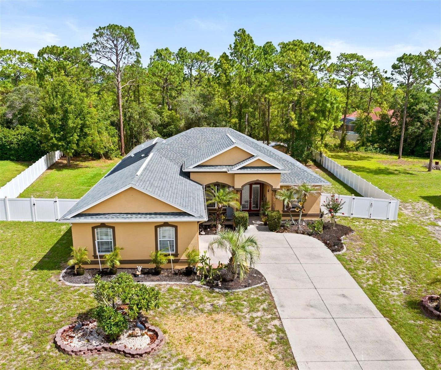 Welcome to your ultimate private oasis! Nestled in a quiet, peaceful neighborhood with NO HOA, this beautifully updated 3-bed, 3-bath, 3 car garage retreat sits on nearly an acre of land, perfectly blending suburban solace with resort-style luxury. Crafted for urban dwellers seeking a peaceful escape, growing families needing space, and entrepreneurs looking for a home that doubles as an inspiring live-work sanctuary, this property truly has it all.

Experience true Florida living with two massive living spaces featuring quad pocket sliders that completely tuck away, opening your home entirely to a spectacular outdoor entertaining area. Step outside to your private paradise featuring an inground pool with a tranquil fountain and an outdoor fireplace perfect for hosting unforgettable gatherings under the stars.

Inside, a thoughtful split floor plan provides maximum privacy for the primary suite, while the versatile second living space is limited only by your imagination—perfectly suited as a high-tech media room, dedicated home office, private mother-in-law suite, or an expansive fourth bedroom. Complete with freshly updated paint throughout and a massive 3-car garage offering abundant storage for vehicles, weekend toys, or a dedicated home workshop, this home delivers an unparalleled lifestyle. Whether you are looking to escape the city bustle, give your family room to grow, or run your business from a peaceful, retreat-like setting, this home delivers. Big ticket items -New paint throughout, roof with transferrable warranty replaced in 2024, new solar heater for pool with 10-year warranty, A/C 8 years old with new condenser, and hookup for generator! Schedule your tour today!