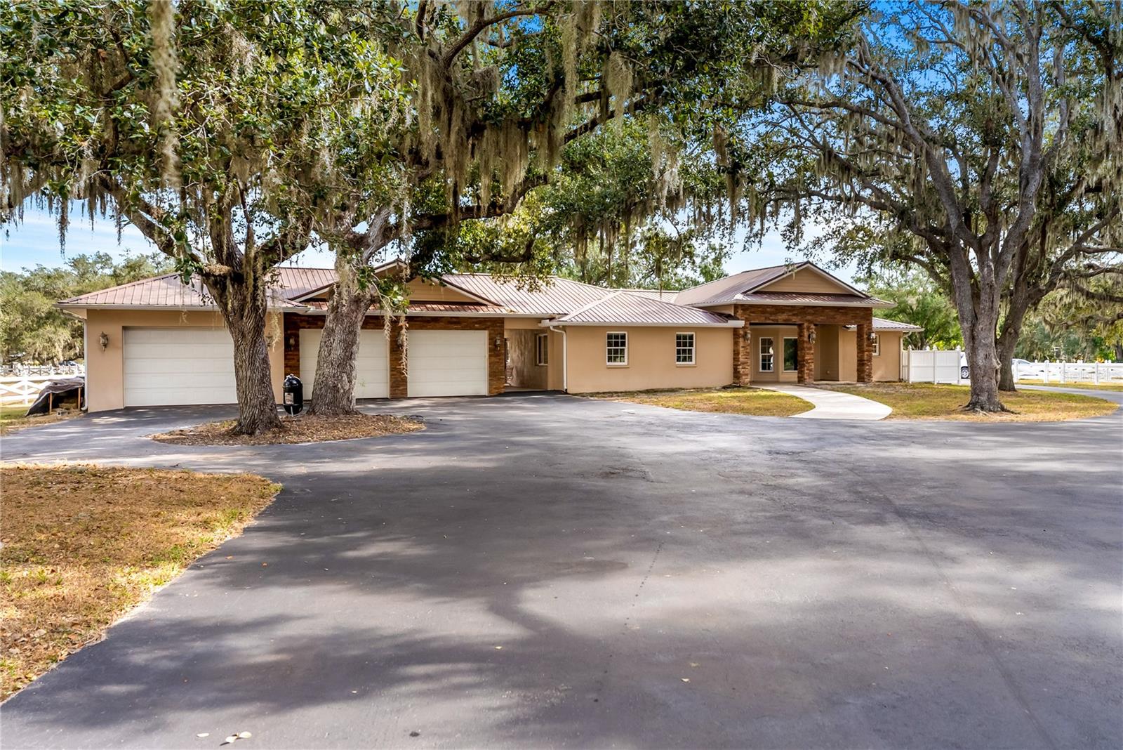 Welcome to a private 5 acre luxury estate, a rare multi residence retreat in the heart of Sarasota. Tucked behind a picturesque canopy of mature oaks and white ranch fencing, this exceptional property offers unmatched space, serenity, and versatility, featuring a beautifully maintained main residence, a fully equipped two story barn home with both upstairs and downstairs living accommodations, a sparkling saltwater pool, and acres of cleared usable land. The main home offers 3 bedrooms plus a large game room with a full closet that can serve as a fourth bedroom, office, or flex space depending on the buyer’s needs, along with multiple living areas and wide open spaces filled with natural light and peaceful views of the pool and surrounding acreage. Meaningful updates include appliances replaced in 2024, a whole house water softener system in 2024 including the apartment, septic pumped in 2024 with a new leech bed installed for both the home and apartment, a saltwater pool pump replaced in 2024, AC replaced in 2020, water heater replaced in 2019, and a durable metal roof from 2008. The expansive kitchen opens to the pool and living areas, complemented by a beautiful stone fireplace and a large bonus room perfect for a billiards room, playroom, gym, or hobby space. Outdoor living shines with a fenced saltwater pool and paver deck, ideal for sunny afternoons and relaxed evenings under the mature oak trees. The two story barn home is divided into two separate units, offering incredible flexibility for multigenerational living or rental income. The upstairs unit features 2 bedrooms and 1 and a half bathrooms, along with 2015 appliances and a private screened balcony overlooking the property. The downstairs unit includes 1 bedroom and 1 bathroom, updated flooring, granite counters, a 2020 stove and dishwasher, and a 2022 refrigerator. The barn also features a metal roof from 2006 and benefits from the recent septic upgrades. The full 5 acres are fully fenced and usable, perfect for horses, gardens, recreational vehicles, or future expansion, all accessed by a beautiful winding paved driveway and an oversized three car garage. This property offers peaceful privacy while still being close to shopping, dining, medical facilities, parks, I 75, and just a short drive to Siesta Key, Lido Key, and the world renowned Gulf Coast beaches.