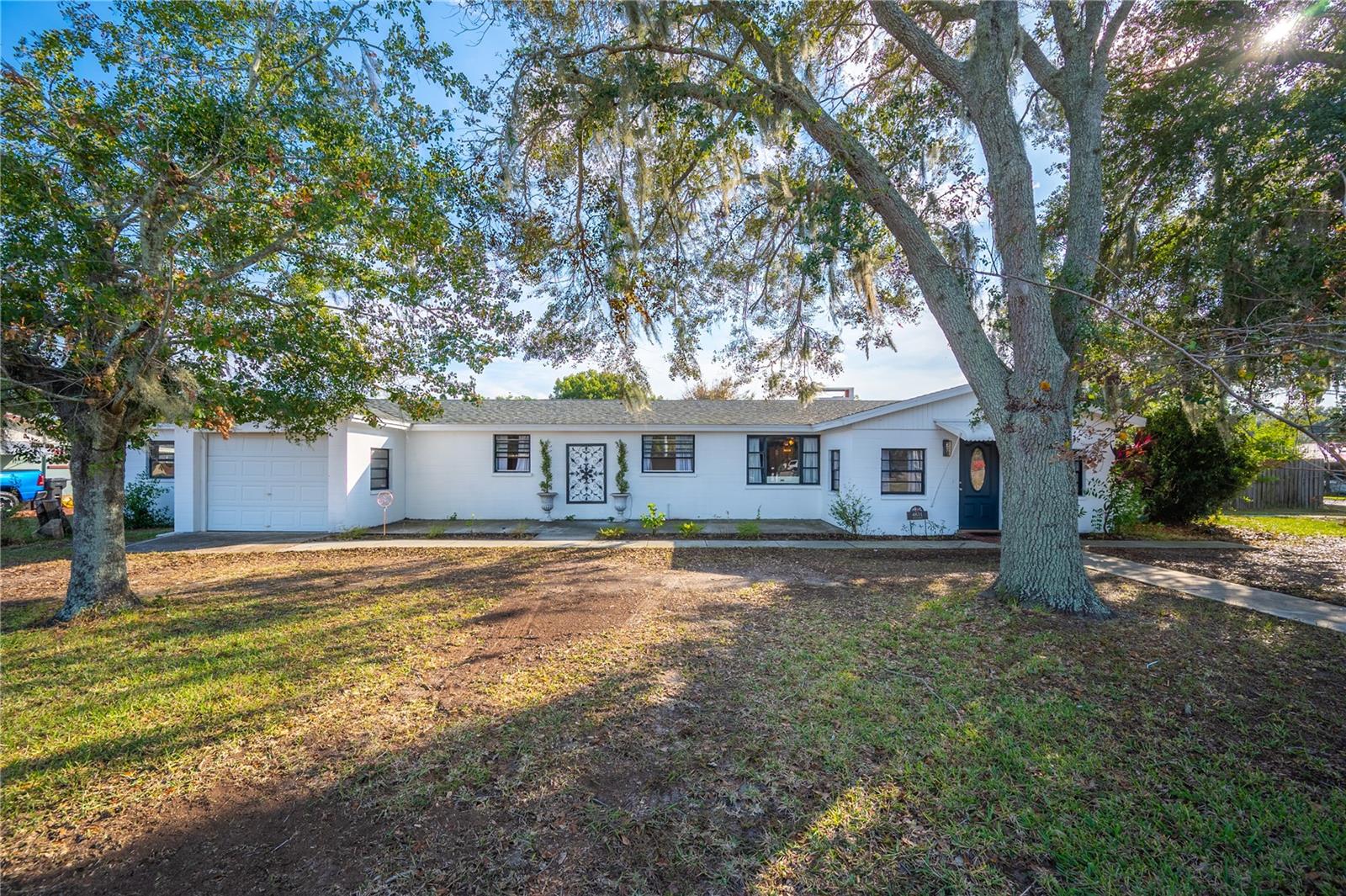 Take a look at this one-of-a-kind fully upgraded north Lakeland home!! 
When you enter the home you will start in the foyer which will lead you to either the family room or the living room, which has a beautiful wood-burning brick fireplace. Throughout the home, you'll notice the easy-to-clean brand-new wood laminate flooring. This home has an upgraded modern kitchen with butcher block countertops, stainless steel appliances, and solid wood shaker cabinets. All of the rooms are very spacious, including the huge walk-in closet in the master bedroom!
The dining room and the master bedroom both have their own entrances that lead you out to the gorgeous outdoor pool area with a cabana that has its own bathroom and shower, perfect for entertaining! Behind the pool area is the separate mother-in-law suite that can be used as rental income or turned into a workspace, as it was previously used as a hair salon. There is a separate entrance to the second master suite that is currently being used as a rental unit with its own bathroom and kitchen efficiency. On just under half an acre with two sheds to give you plenty of storage and space, along with a massive cement block structured carport/work area, with electric and water hook-up, so bring your toys!! Conveniently located near I4, making commuting a breeze! This home is definitely a rare find, schedule your showing today!