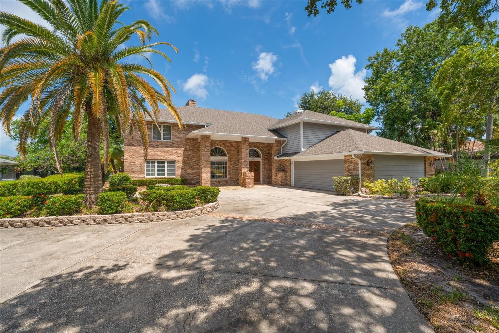 Nestled within the highly coveted Harbor Bluffs waterfront neighborhood, where much of this stretch rests atop natural limestone bluffs rising approximately 20 feet above sea level, this exceptional waterfront residence offers a rare blend of timeless elegance, flexible living spaces, and the quintessential Florida lifestyle. From the moment you arrive, lush tropical landscaping and impressive curb appeal create a warm and welcoming first impression. Step through the front door and discover a light-filled interior where neutral tones, rich wood flooring, and soaring ceilings create an atmosphere that is both inviting and sophisticated. A spectacular catwalk overlooks the main living area below, adding architectural drama while drawing your eye toward the spacious family room, where a handsome brick fireplace serves as the heart of the home. Thoughtful custom built-ins in both the dining room and kitchen add warmth, character, and functionality throughout. Designed to impress even the most discerning chef, the enormous kitchen features a large center island with stovetop and seating, granite countertops, a Sub-Zero refrigerator, Sub-Zero freezer, wine fridge, pantry, and abundant workspace for entertaining family and friends. The flexible floor plan is ideal for multigenerational living, offering two primary suites—one conveniently located on the main level and an extraordinary retreat upstairs. The upper-level primary suite is truly a private sanctuary, complete with a dramatic double-sided fireplace, an expansive walk-in closet with custom built-ins, breathtaking water views, and a luxurious en-suite bath featuring dual vanities, a relaxing soaking tub, and a spacious walk-in shower. Additional bedrooms are generously sized, filled with natural light, and offer ample closet space, while an upstairs laundry room with a utility sink and mini refrigerator adds everyday convenience. Two separate staircases provide easy access throughout the home and enhance the thoughtful design. Step outside and experience the very best of waterfront living. A sparkling pool and spa are surrounded by multiple entertaining areas designed for both intimate gatherings and grand celebrations with an outside tiled shower room and
separate bathroom. Beyond the pool, a sprawling lawn stretches toward the water's edge, where a Trex dock and private boat slip await boating enthusiasts eager to explore the Intracoastal waterways and Gulf beyond. Perfectly positioned near local restaurants, boutique shopping, and the area's world-famous white sand beaches, this remarkable Harbor Bluffs residence offers an unparalleled opportunity to enjoy luxury waterfront living at its finest.