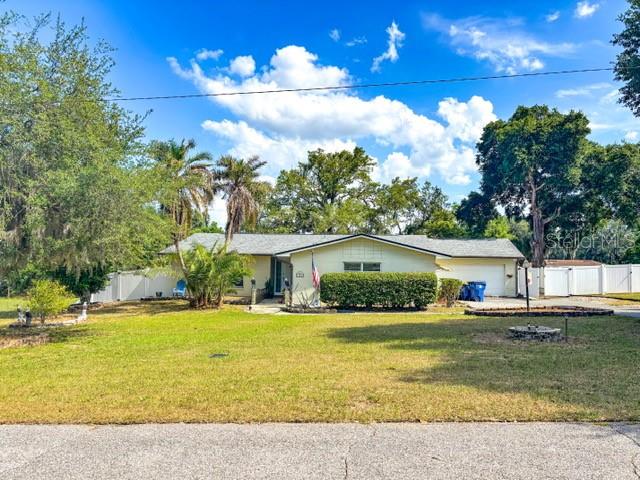 Nestled within a desirable waterfront community, this property is truly a fisherman’s dream. Bring your boat and enjoy the natural beauty of Little Lake Harris, where exceptional views can be enjoyed right from your windows. With no HOA, you’ll have the freedom to store your boat in the backyard or in the spacious garage. Residents also enjoy access to the Harris Chain of Lakes through a community boat ramp, along with scenic walks to the shoreline, Griffin Park, and the lakefront promenade—a favorite local pastime.  
Inside, the home features new vinyl laminate flooring throughout the main living areas (with tile already in place in the wet areas) and fresh paint in the living room, dining room, and library. The flexible layout includes two additional rooms, a two-car garage, and generous storage options. Large windows, bright interiors, and easy-care flooring (no carpet) create a cheerful, inviting atmosphere. Custom built-in cabinetry elegantly separates the den and dining room, while the glass-enclosed, under-air Florida room overlooks a spacious yard shaded by a beautiful oak tree.  
Conveniently located just minutes from the Florida Turnpike, this quiet community also offers a family-friendly park system, fishing pier, basketball court, and local library. Nearby attractions include the renowned Mission Inn Resort & Spa, where golf enthusiasts can enjoy world-class courses and exceptional dining.