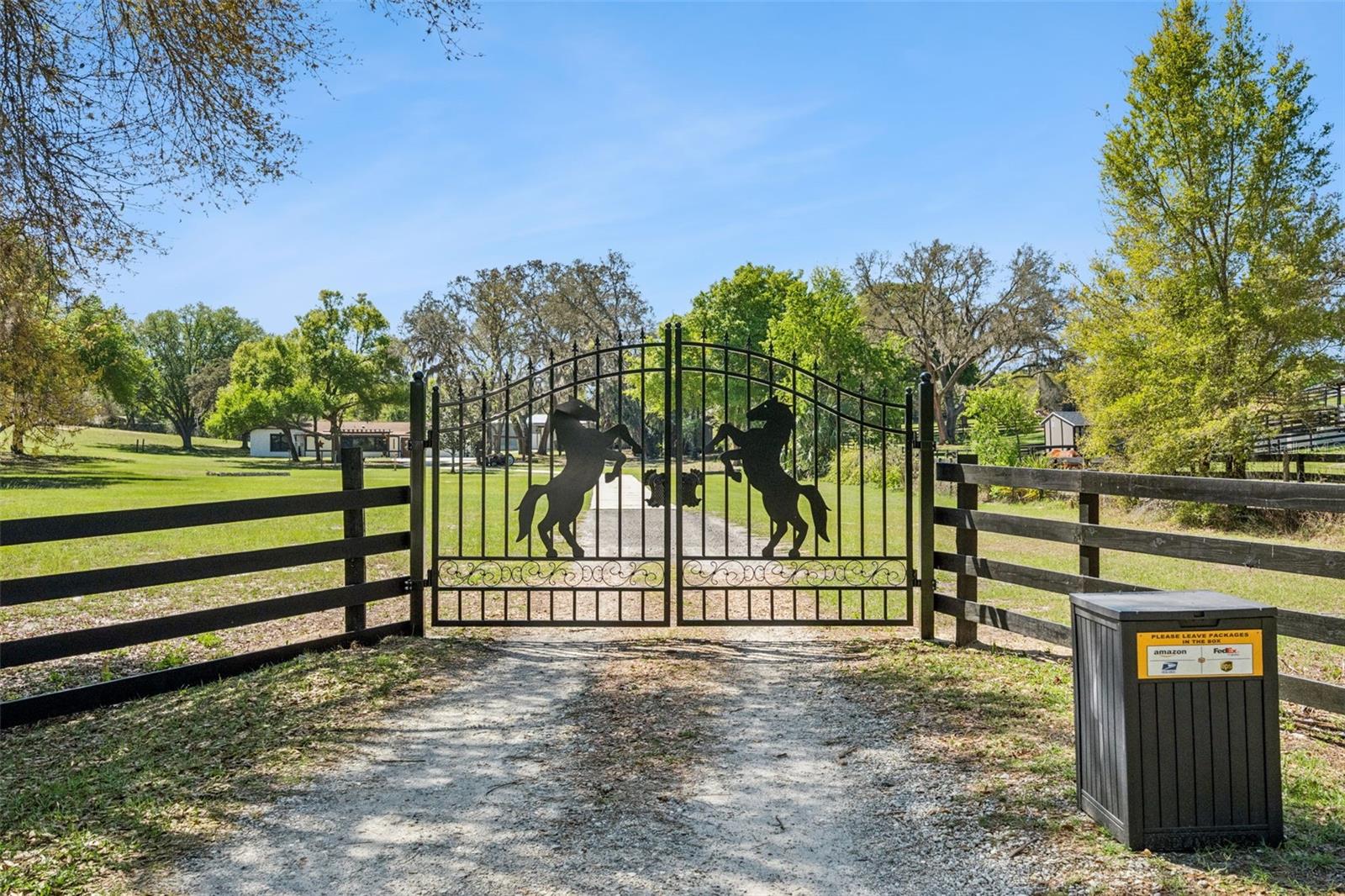 Welcome to this stunning, fully renovated modern farmhouse nestled within the peaceful Vinola Gardens neighborhood in the highly sought-after Montverde area, offering old Florida, small town living. Set on 4.41 acres with NO HOA, this exceptional property provides privacy, modern upgrades, and powerful income-producing potential. The main residence features extensive renovations including new stucco, full interior/exterior paint, premium Andersen windows and patio doors, porcelain flooring throughout, updated plumbing and electrical, a new breaker box, new AC/furnace with UV purification, skylights, upgraded lighting, and remodeled bathrooms. Two brand-new kitchens showcase granite waterfall countertops, custom cabinetry, and designer finishes. A separate one bedroom and bathroom apartment and an additional studio with bathroom are outstanding rental income options or flexible multigenerational living. The living room wall can easily be opened to re-connect the apartment to the main home, giving buyers the option to expand the primary living space if desired. The apartment features updated finishes and new flooring, while the studio has new flooring along with beautiful cedar accents and dedicated climate control. The property includes a 48Lx21W Steel building with two 10-foot-tall garage doors perfect for storing equipment, recreational vehicles, or outdoor toys. Steel building has three covered sides—ideal for boats, RVs, trucks, trailers, and more. Two additional sheds (10x16 and 12x24) add versatile storage options. The property also offers 10 conveniently placed outdoor water spigots around the pole barn, both sheds, and the front of the home. Land renovations include an extended driveway, covered porches, new sidewalks, pergolas, painted sheds, new front fence and gate, a full landscape overhaul, new sod, a sprinkler system with controls, French drains, water run-off enhancements, a new drain field, new water heater, and a new water tank. Bring your Barn plans, horses, farm animals to this remarkable acreage offers endless possibilities. Additional custom features include cedar accents, a custom bookshelf, a TV enclosure, a remodeled laundry room + extra storage, and a fully finished 4th bedroom suite with private bath. Located just minutes from shopping, hospitals, and the world-renowned Montverde Academy, this property delivers acreage, luxury, flexibility, and unmatched income potential, tucked away in your own private nature preserve with a beautiful oak grove to take your morning strolls through. Don't miss out on this one-of-a-kind opportunity that offers big city access while living tucked away in beautiful country charm.