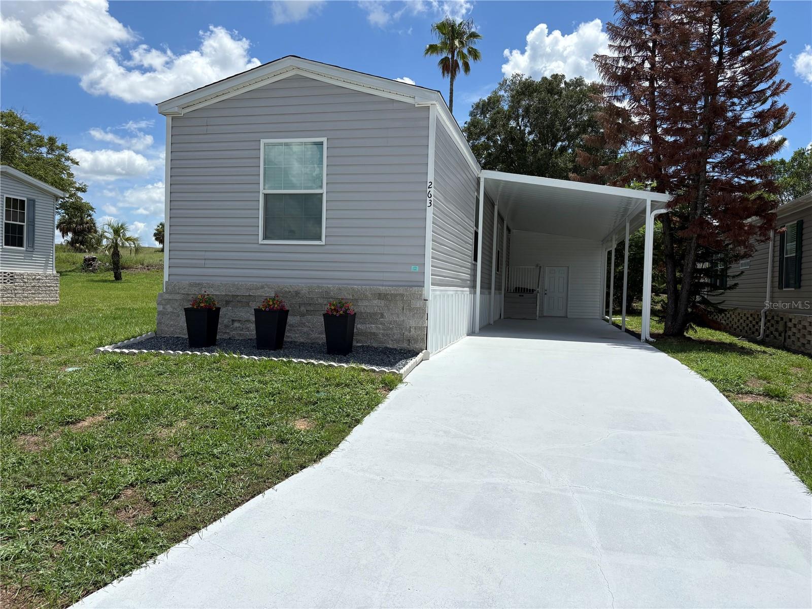 Welcome to your brand-new, never-lived-in home, offering 3 bedrooms and 2 bathrooms in a vibrant 55+ active community. This modern  residence delivers the comfort of new construction paired with a low-maintenance lifestyle designed for easy living — and you own the lot, so there's no lot rent.

Inside, you’ll find stainless steel appliances, a bright open layout, and thoughtfully designed spaces perfect for everyday enjoyment. Outside, the covered carport with an attached storage shed provides convenient parking and extra room for tools, hobbies, or seasonal items. The lot offers additional space that may allow for future expansions or add-ons, subject to buyer verification with the HOA and county. The community also provides designated outdoor storage areas for boats and RVs, giving you even more flexibility for your recreational lifestyle.

Residents enjoy a friendly, amenity-rich community featuring a sparkling pool, shuffleboard courts, and a clubhouse ideal for social gatherings and activities. Only one occupant needs to be 55+ to qualify for residency, making the community accessible while still maintaining its active-adult atmosphere. The low monthly dues include water, sewer, cable, internet, and lawn maintenance, allowing you to enjoy the Florida sunshine without the burden of extra upkeep.

This move-in-ready home is the perfect opportunity to enjoy a fresh start in a welcoming and well-appointed 55+ neighborhood.
