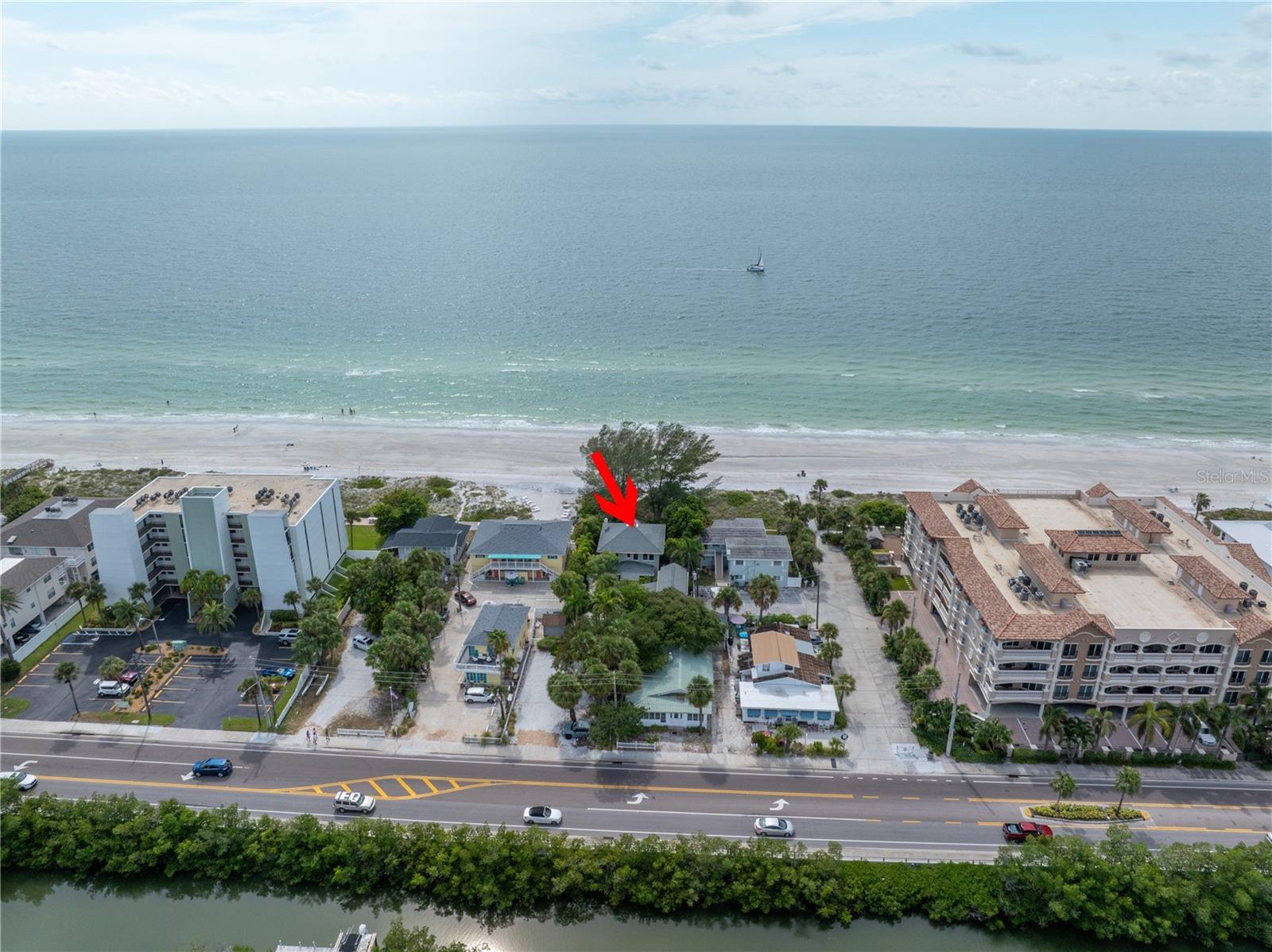 Under contract-accepting backup offers. PRICE REDUCED!!! If you've been dreaming of owning a generational income producing property. Look no further. Come make memories with your family for years to come and have this property virtually pay for itself. This is a highly sought after rental with repeat customers. Who build their own memories at this amazing beach front front property. It's walkable to restaurants, water parks, shopping and ice cream. Who doesn't want ice cream at the beach. Don't let this opportunity pass you by...  

This exquisitely curated home and duplex (one bedroom one bath downstairs and upstairs) offers the ideal blend of coastal charm and modern convenience, making it perfect for creating lasting memories for years to come. Zoned for short-term rentals, this property offers a unique opportunity to enjoy breathtaking sunsets while covering your expenses with rental income. With reservations already on the books, you can start benefiting from this investment right away. Recent updates include new AC units, an upgraded electrical service panel, a water heater, mini-splits, and a refreshed downstairs duplex – all completed within the last few years. Situated on an expansive lot of nearly 1/3 acre, this property is zoned for up to 10 units, offering limitless potential. Don’t miss out on this exceptional opportunity to own a piece of paradise! 

MAIN HOUSE TOTAL SQ FT 2648 APPROXIMATELY
DOWNSTAIRS DUPLEX UNIT 448 SQ FT APPROXIMATELY
UPSTAIRS DUPLEX UNIT 225 SQ FT APPROXIMATELY 

PLEASE CHECK OUT FLOR PLANS ATTACHED IN THE PHOTOS FOR ROOM SIZES. Buyer and buyers agent are responsible to confirm all room sizes.