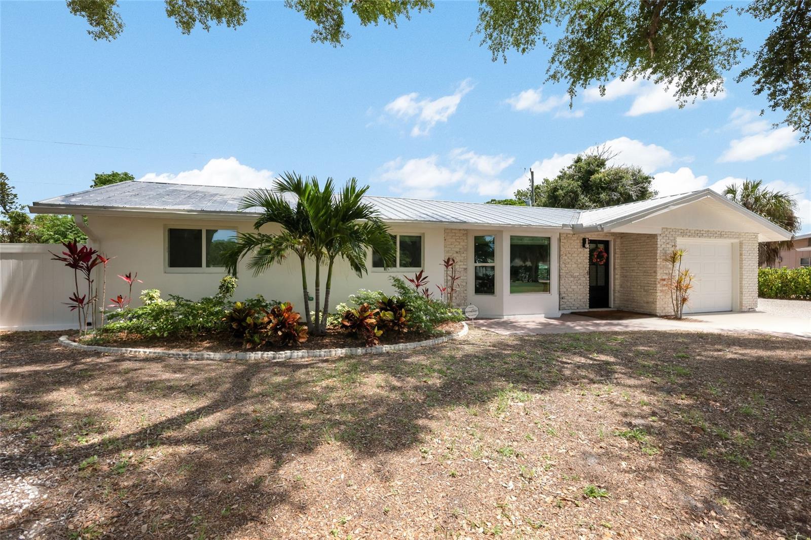 This beautifully renovated South Gate home is the definition of move-in ready. Freshly updated from top to bottom, this mid-century gem combines timeless style with modern comfort in one of Sarasota’s most desirable neighborhoods.
Step through the striking new front door into a bright, welcoming living space featuring gleaming polished terrazzo floors, a charming bay window, and an effortless open-concept layout. New recessed LED lighting throughout adds warmth and sophistication to every room.
The stunning kitchen is both stylish and functional, showcasing quartz countertops, a pearl tile backsplash, a spacious island, and new Samsung appliances. An inviting eat-in area overlooks the large screened lanai, while glass French doors create the seamless indoor-outdoor living experience that makes mid-century homes so special. Whether gathering around the island or hosting dinner in the adjacent dining space, this home was designed for entertaining.
The thoughtfully updated bedrooms and bathrooms continue the home’s fresh, clean aesthetic, while the oversized indoor laundry room offers abundant storage, new Samsung washer and dryer, and durable epoxy flooring.
Outside, the expansive screened lanai and newly refinished pool create the perfect private retreat. With new pool equipment and plenty of outdoor space for relaxing or entertaining, the backyard is ready to impress.
Major upgrades include a new metal roof, impact windows and doors, newer AC system, all-new plumbing, and a newer hot water heater — offering peace of mind for years to come.
Located in the highly sought-after South Gate neighborhood, this home places you just minutes from Sarasota’s world-famous beaches, vibrant downtown, shopping, dining, and easy freeway access — all within 10 minutes.
A renovation this exceptional is rare. Don’t miss your opportunity to make this stunning Sarasota home yours.