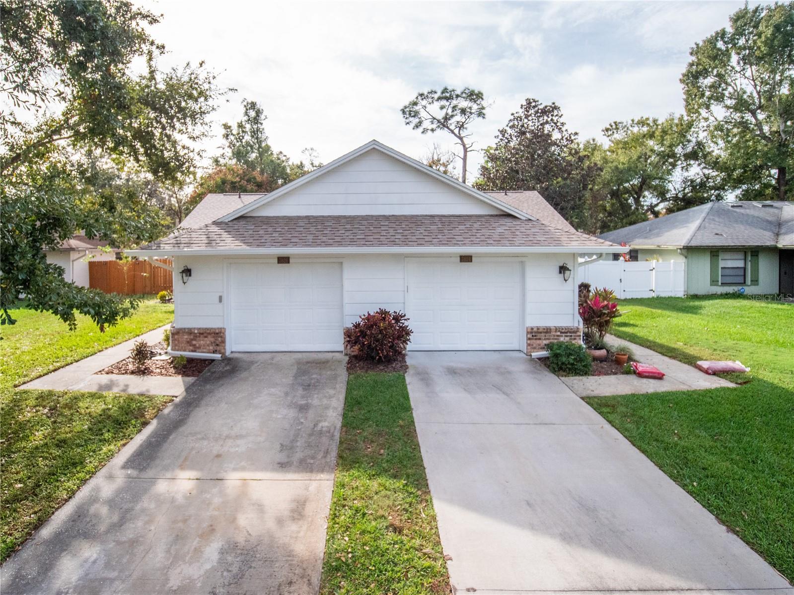 Lovingly updated two-bedroom, two-bath half duplex located off Chickasaw Trail in the desirable Richwood Estates neighborhood. This move-in ready home is nestled on a quiet cul-de-sac. The screened-in front porch is the perfect setting to comfortably greet your guests. Upon entering the home, you are surrounded by an abundance of natural light. Vaulted ceilings and an open floor plan seamlessly connect the kitchen to the family room. The kitchen features granite countertops, a beautiful backsplash, GE profile stainless steel appliances, custom wood cabinets with matching hardware, crown molding, an eating space, and a breakfast bar. Entertain your guests or spend quality time with your family in the spacious family room. Roomy primary bedroom with crown molding, ceiling fan, and walk-in closet. Primary bath with a stand-up tile shower. Ample-sized secondary bedroom with ceiling fan. The second bathroom has an updated vanity with an inlaid sink, and a tile shower with tub. Enjoy your favorite morning or afternoon beverage in your screened-in patio with a fully fenced backyard. New roof replaced in 2022, AC & water heater 2020. Centrally located close to schools, shopping, dining, Valencia College and the University of Central Florida, the 408, 417 Greenway and so much more. Act fast before this beauty is gone.