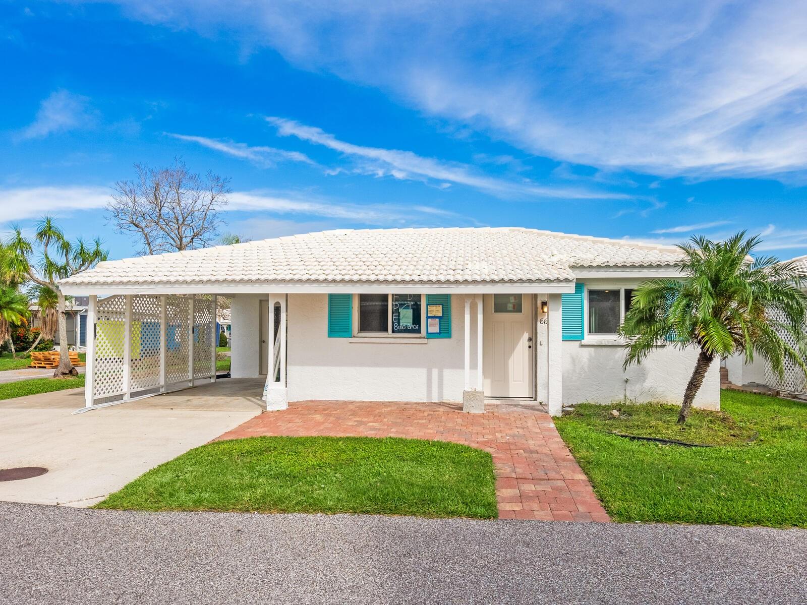 New photos coming on this beautifully updated free-standing villa in Spanish Main Yacht Club on Longboat Key, a warm and vital boating community with private beach access, pool, clubhouse and boat slips. The community is undergoing a renaissance of sorts as many units (including this one) did have water intrusion in the summer storms of 2024. This owner contracted with the community contractor. has paid related assessment and work is nearly completed! This unit has a bright open floor plan and hurricane windows. Main living area has tile flooring and both bedrooms will have new carpet. There are two bonus areas, one is adjacent to the primary bedroom and could be a private reading area or office and the other adjoins the great room. Once completed, this unit will have two new baths, new appliances, kitchen updated, new doors and new paint throughout. This villa is on the corner and has a much-desired additional parking pad, giving as many as four parking spaces depending on car size. The laundry room, typical of Florida, is in a separate room under the carport. Longboat Key is paradise. A barrier island off Sarasota, where you can find wonderful restaurants, community tennis facilities, parks, bike lanes and a short drive to Sarasota and Anna Maria Island.