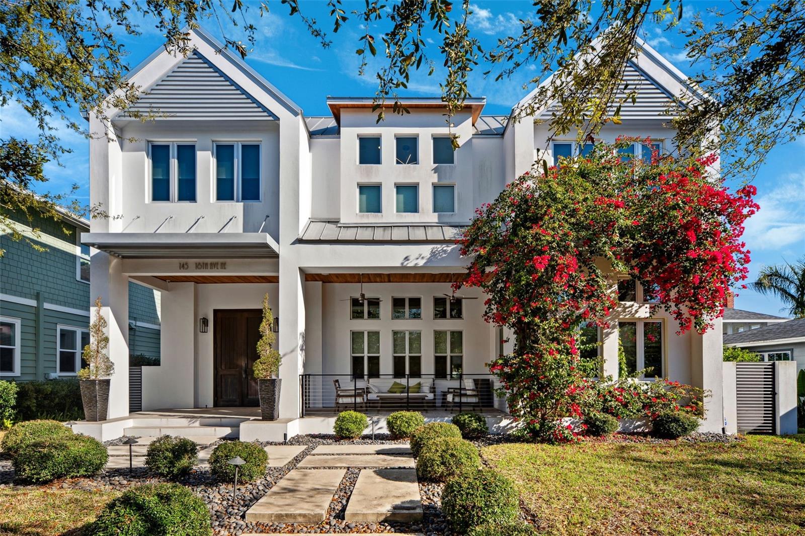 Luxurious custom home in historic Old Northeast! Safe from the 2024 hurricanes, this home had no damage and features impact windows, a whole-home generator and is located in ZONE X where NO FLOOD INSURANCE REQUIRED. This stunning estate, built in 2015, offers a private courtyard with pool and outdoor kitchen, a separate private guest suite, high-end finishes and luxury features throughout that make this a one-of-a-kind Dream-Home. A welcoming covered front porch leads into a bright and inviting foyer that opens into the custom kitchen, dining room, and living room where natural light enhances the home’s warm yet contemporary design. The first floor boasts elegant European oak hardwood flooring and 14-foot ceilings.  At the heart of the home is the gourmet chef’s kitchen, outfitted with custom motorized soft-close cabinetry, a prep island with seating and floor lighting, a natural gas Wolf range, built-in oven and microwave, a Sub-Zero refrigerator, a built-in wine fridge, and a butler’s pantry for additional storage. The combined dining and living rooms are spacious and open with ample natural lighting and features a gas fireplace. French doors open from the living room to a covered poolside courtyard, creating the perfect combination of indoor and outdoor living. The tranquil saltwater pool, heated and complete with fountains, provides the ultimate space for relaxation. The covered area features an outdoor kitchen with a natural gas grill and refrigerator, ideal for entertaining. The first floor also includes a home office, a half-bath with access to the pool, laundry room, mud room, additional storage, and access to the 2-car garage. Moving upstairs, the oak flooring continues to flow along lighted steps and custom handrails. On the second floor you will find the Primary Suite, two guest bedrooms, a Jack-and-Jill guest bathroom, media room, and loft. The Primary Suite features a Juliet balcony that overlooks the courtyard and pool, an unbelievable spa-like bathroom and a custom 14x14 walk-in closet. The Primary bathroom features Italian marble flooring, a soaking tub, a large walk-in shower with built-in bench, dual sinks on a floating vanity, and a separate water closet. The custom walk-in closet features a built-in makeup vanity for added elegance and functionality. The two guest bedrooms are well suited with a convenient and spacious guest bathroom featuring separate vanities and a separate water closet.  Along with the bedrooms, the second floor offers a media room with a wet bar, reading/library area, second floor laundry closet as well as a loft for an additional play area. Adding to the home’s exceptional layout, a private second-floor studio apartment with its own entrance off the pool area offers a spacious bedroom/living area, a kitchenette with a refrigerator, generous closet space, and a full bathroom—ideal for extended guest stays or as an in-law suite. Additional home features include a smart security system and cameras, 2-car garage with alley access, Golf cart parking, dog run, custom lighting, and more.  Located just blocks from downtown St. Petersburg, this home provides easy access to upscale restaurants, boutique shopping, museums, art shows, concerts, and waterfront parks. Take a quick golf cart ride to the St. Petersburg Pier, enjoy a scenic jog along the bay, or simply soak up the endless entertainment and sunshine that this vibrant city has to offer. Don’t miss the chance to experience this extraordinary home!
