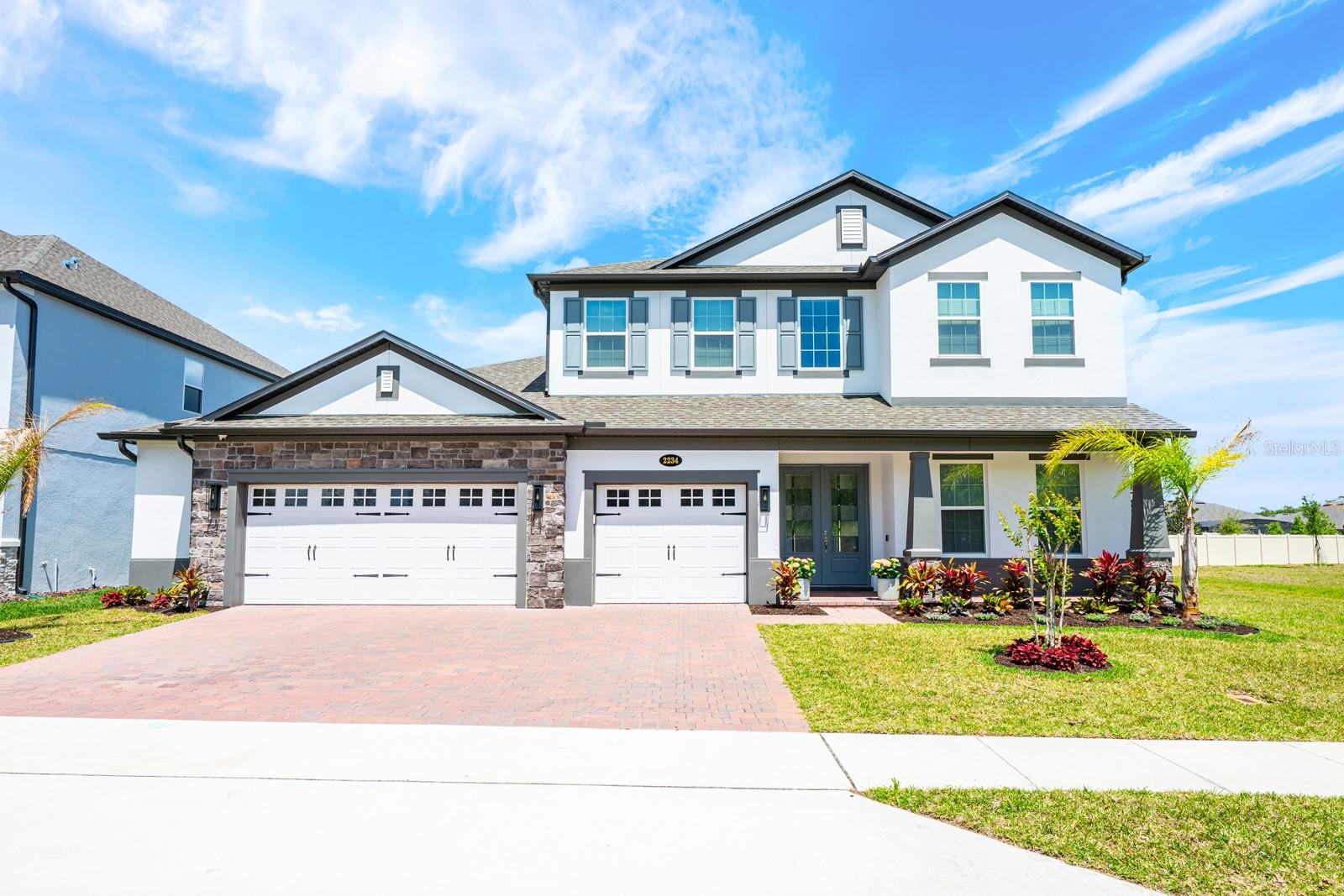 Seller may consider buyer concessions if made in an offer ~ Built in 2024 and thoughtfully UPGRADED throughout, this nearly new 5-bedroom, 4.5-bath home + BONUS/LOFT offers exceptional space, style, and functionality in the GATED Red Ember South community of Oviedo – all in a location known for TOP-RATED SCHOOLS and just steps from Hagerty High School! Why wait for new construction when this beautifully finished home is ready now? Set on a spacious CUL-DE-SAC LOT, this home delivers standout curb appeal with a paver driveway, stone accents, manicured landscaping, and an oversized 3-car garage. Inside, a light-filled TWO STORY FOYER greets you and flows effortlessly into the dining area and the open living space beyond, creating an inviting layout designed for both everyday living and entertaining. The living room is anchored by a BUILT-IN ELECTRIC FIREPLACE with CUSTOM BENCHES on either side, while a dramatic wall of 3 OVERSIZED SLIDING GLASS DOORS fills the home with NATURAL LIGHT, opening to the COVERED LANAI and FULLY FENCED backyard, offering a seamless INDOOR/OUTDOOR LIFESTYLE. At the heart of the home is a gorgeous chef’s kitchen designed to impress, featuring QUARTZ COUNTERTOPS, rich cabinetry extending to the ceiling, soft-close features, under-cabinet lighting, built-in UPGRADED APPLIANCES, a tiled backsplash, pantry storage, and a large contrasting ISLAND with breakfast bar seating. The OPEN CONCEPT design keeps everyone connected whether cooking, dining, or relaxing! Your MAIN FLOOR PRIMARY SUITE is privately situated on its own wing of the home and overlooks the backyard. This tranquil retreat includes a massive WALK-IN CLOSET and a beautifully appointed en-suite bath with split vanities on either side of a soaking tub, plus a large glass-enclosed shower with elegant tile work and built-in niches. The GUEST BEDROOM SUITE on the opposite side of the main floor also features a walk-in closet and private en-suite bath, offering flexibility for guests or multi-generational living. Across the foyer, the mudroom area includes the laundry room and a convenient half bath for guests, keeping everyday life organized. Upstairs, the home continues to impress with a huge BONUS/LOFT perfect for a media room, game space, or secondary living area, along with additional bedrooms (to note; 3 of the home’s 5 bedrooms are en-suites!) – providing privacy and comfort for everyone. A separate 11x10 STORAGE ROOM on the second floor adds valuable extra storage space rarely found in newer homes. Throughout the home, LUXURY VINYL PLANK FLOORING runs across the main level, while carpet adds comfort in the upstairs bedrooms and loft. Every detail feels intentional, creating a home that is as functional as it is stylish – cohesive, curated, and designed for modern living! Located just off Old Lockwood Blvd, residents enjoy quick access to Hagerty High School, area parks, shopping and dining, plus convenient routes to SR 417, SR 50, 434, and 426, making commuting around Oviedo and the greater Orlando area a breeze. This versatile layout offers room to grow both inside and out, combining the benefits of new construction with thoughtful upgrades already in place. This exceptional Red Ember South home is ready to welcome you – call today to schedule your tour and experience Oviedo living at its finest. WELCOME HOME!