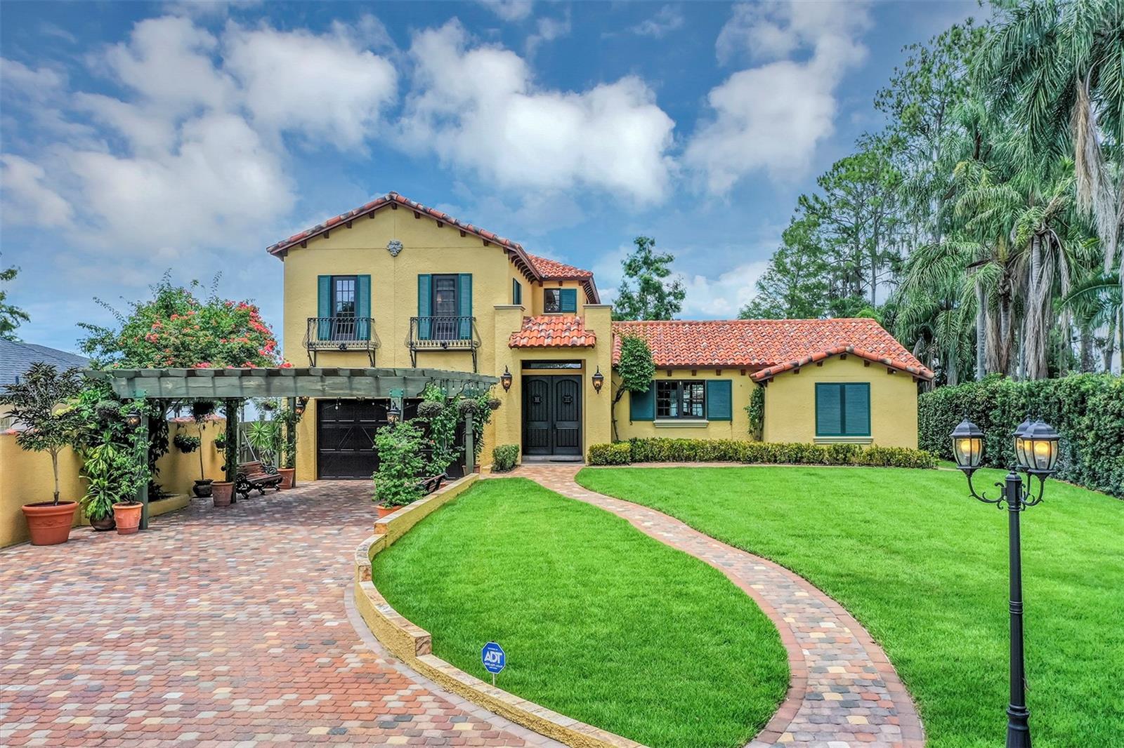 Discover this exquisite lakefront property nestled on over 1.9 acres with more than 100 feet of water frontage on LAKE TIBET and part of the Butler Chain of Lakes. This home offers breathtaking views and absolutely stunning sunsets.   As you drive onto the winding paver circular driveway with lovely fountain and beautiful landscaping, you will notice the terracotta tile roof and the undeniable architectural style of this home. The 2 car garage has EV charging station. Once you enter the home you will be impressed with the whole house automation system, motorized window treatments, travertine floors, gas fireplace and crown moulding.  At the heart of the home, the chef’s kitchen featuring elegant custom cabinetry, boasts of a large island, granite counter , 2 Sub Zero appliances, reverse osmosis system, pot filler, Wolf steamer, warming drawer and wine fridge.  Downstairs are 2 additional bedrooms with en-suites each with special features.  Upstairs, You will admire the solid hardwood flooring and attention to details.  Primary suite overlooks the breath taking view of Lake Tibet  and features en-suite adorned with stone flooring with stand alone tub and separate shower. The primary suite has a large walk-in closet with a custom built closet system w/safe and another separate closet. Two additional bedrooms upstairs share a full bath. 
A sparkling pool w/spa within the screened patio offers a tropical escape with a summer kitchen featuring, large grill, hotplate, warming tray, pot filler and  TV and misting station.  The  secondary covered patio outside the screened enclosure is perfect for an additional quiet oasis to enjoy your stunning views. The newly re-built dock and covered boat house w/lift (2023) with composite decking comes complete with electric & water is perfect for the enjoyable days and nights on the water.  Other features include updated septic system(2024), new pool pump (2025), H2O Water Softener system, No Home Owner Association.  Seller is leaving all electronics within the home. Conveniently located minutes from “Restaurant Row”, Disneys Springs, Bay Hill and zoned for “Top Rated” Schools.  Schedule private tour of this remarkable home today.