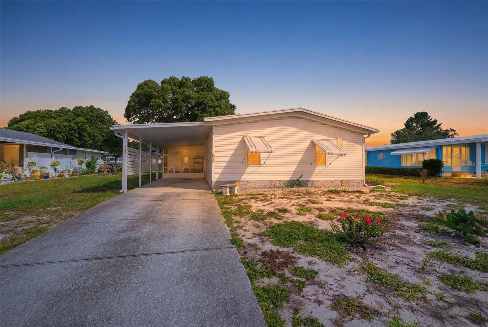 Located in the desirable 55+ golf course community of Brookridge, this well-maintained 2-bedroom, 2-bath manufactured home sits on a 0.20-acre lot and offers comfortable living with a 2-space carport and inviting indoor and outdoor spaces. A screened front porch welcomes you to the home, where a few steps lead to the main entry. Inside, the spacious living room immediately greets you with wood-look vinyl flooring that extends throughout the home, vaulted ceilings, and an open layout that creates a bright and welcoming atmosphere. Adjacent to the living room, the kitchen is designed for both everyday living and entertaining, featuring abundant cabinetry, spacious countertops, a center island, breakfast bar, dual sink positioned beneath a window, and plenty of workspace for meal preparation. Just beyond, the breakfast nook serves as the main dining area and features double sliding glass doors that open directly to the rear screened porch, creating an easy flow between indoor and outdoor living. To the left, the generously sized family room offers additional living space with the same flooring, a bank of windows that fills the room with natural light, and a convenient bar counter ideal for entertaining or casual gatherings. The spacious primary suite includes a large built-in closet, a window for natural light, and a beautifully updated en-suite bathroom featuring crown molding, a single vanity with generous counter space, a step-in shower, and a window. Bedroom 2 offers similar comfort with crown molding, a built-in closet, and a window, while the nearby guest bathroom also features crown molding, a single vanity, and a tub-shower combination. The laundry room provides built-in shelving, utility shelving, abundant cabinet storage, countertop workspace, and direct access to the front screened porch for added convenience. At the rear of the home, the fully screened porch overlooks the backyard, offering a relaxing place to enjoy the Florida weather year-round. Residents of Brookridge enjoy a gated 55+ golf course community with amenities that include golf, a clubhouse, swimming pool, tennis, pickleball, shuffleboard, and a full calendar of social activities, all while being conveniently located near shopping, dining, medical facilities, and the Suncoast Parkway for easy access to Tampa and surrounding areas.