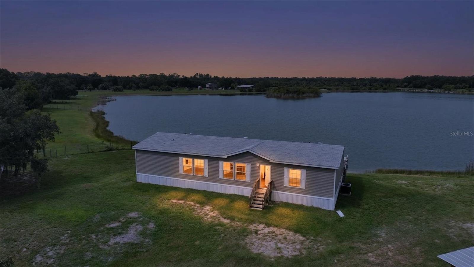 Tucked away at the end of a quiet dead-end road, where the only traffic is the occasional breeze rustling through the trees, you'll find your slice of peace, privacy, and possibility. Welcome to lakefront living at its finest: a 2024-built home where everything is brand new and the lifestyle is straight out of a dream. Picture sipping your morning coffee on the back porch while watching the sunset dance across the water. Or casting a line off your own private dock while others paddle around in a canoe. This isn't just a home! It's a slower pace, a fresh start, and a space where you can finally breathe. Step inside and you're greeted with a thoughtful, open floor plan, beautiful natural light, and the kind of finishes that make you say "wow" without even trying. The kitchen is a showstopper and not just because of the modern touches and crisp design, but because of the picture-perfect view of the lake from the kitchen sink. (Yes, you'll actually want to do the dishes.) Three spacious bedrooms, two gorgeous bathrooms, a soaking tub that practically begs you to unwind, walk-in closets, and an indoor laundry room complete the practical side of things, but this property is all about lifestyle. With zoning that allows animals, gardening, and homesteading, your chickens, raised beds, or mini-farm dreams are totally welcome here. Road frontage on two sides, total privacy at the end of the street, and no renovations to stress over because everything is already done for you. Come live the lake life, plant your roots, and write your next chapter somewhere truly special. This one is calling your name. Entrance for this property is at the end of SE Foster Avenue.