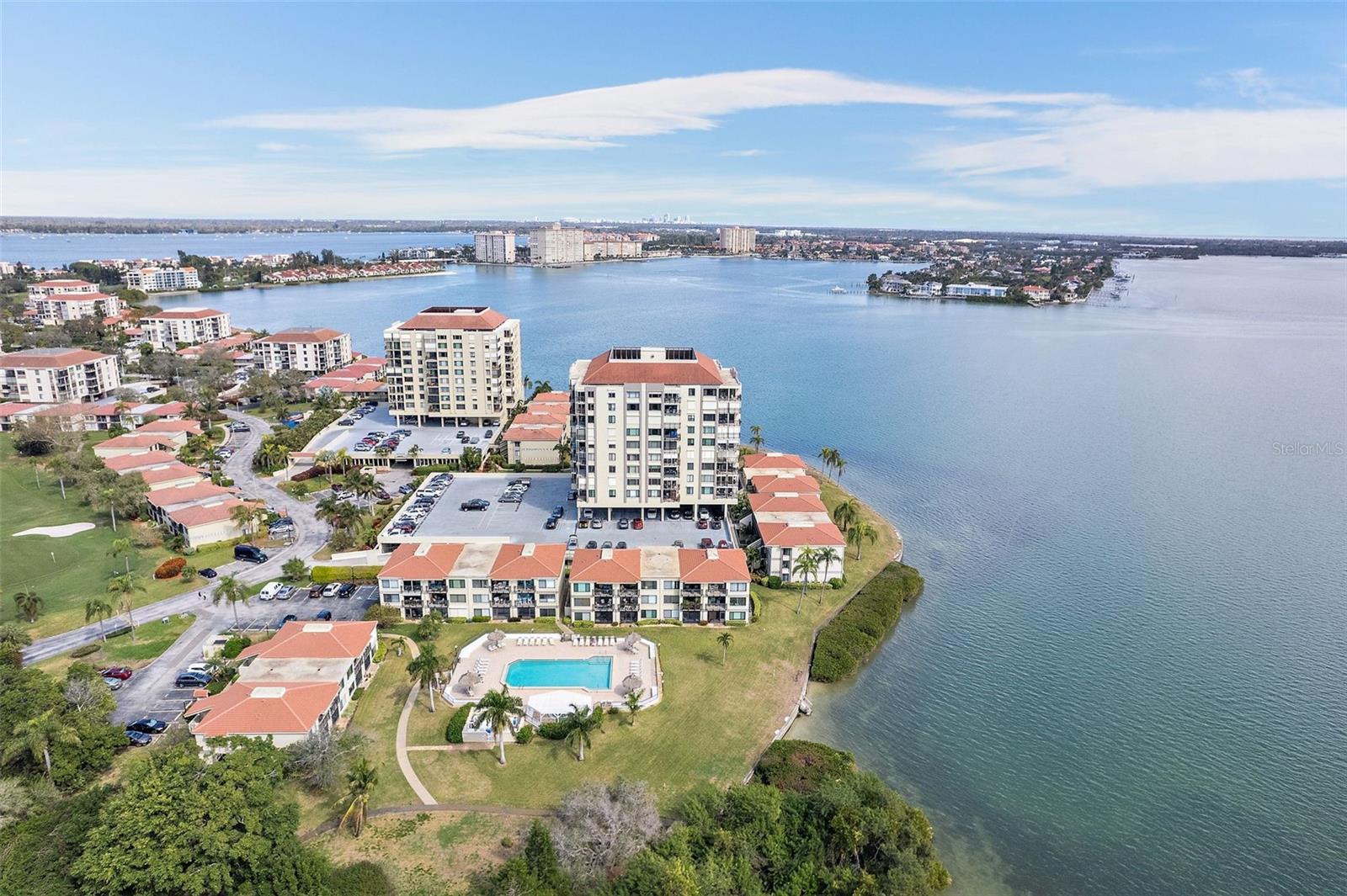 Time to start living the Florida Lifestyle. Enjoy sunrise and sunsets from this awesome corner unit. Fully remodeled and READY FOR A QUICK CLOSING! Sold TURNKEY! Exquisite Contemporary Corner Unit condo offers views of serene Boca Ciega Bay, seamlessly blending indoor elegance with outdoor beauty. Step inside to discover a bright open floor plan adorned with updated flooring and soothing coastal paint colors that invite the tranquility of the waterfront indoors. The spacious living and dining areas boast captivating vistas of the bay, creating an idyllic backdrop for both relaxation and entertaining. The heart of this home is its completely updated kitchen, featuring luxurious quartz countertops, sleek Frigidaire Stainless Steel appliances, and contemporary 24” X 12” floor tiles. A convenient breakfast bar enhances the open concept design, facilitating seamless interaction with guests while preparing culinary delights. This thoughtfully designed condo offers a spacious 2 bedroom and 2 full bath split plan for added privacy. The primary bedroom indulges with a remodeled en-suite bathroom boasting a raised vanity, quartz counters, travertine floors, and a full tile shower, complemented by a large walk-in closet and breathtaking East-facing sunrise views. Step out onto the large corner balcony to soak in the panoramic vistas of the bay, where North and East-facing views await. Hurricane shutters on all windows and balcony openings provide peace of mind during inclement weather. Enjoy the convenience of a washer and dryer inside the unit, along with assigned parking and ample guest parking for visitors. Embrace the vibrant community atmosphere with clubhouse amenities including bingo, poker, and leisurely poolside lounging. Outside, indulge in the resort-like amenities including an amazing heated swimming pool, separate spa/hot tub, and the added bonus of a waterfront community with a golf course running through the grounds. Conveniently located near St. Pete Beach and the iconic Don Cesar hotel, as well as the pristine beaches and park at Fort DeSoto. Explore the eclectic downtown St. Petersburg just 15 minutes away, offering waterfront strolls, fine dining, cultural experiences at the Dali museum, and entertainment at the Mahaffey Theater. Best of all this unit is being SOLD FURNISHED, TURN KEY (only excluding fiesta ware dishes in kitchen cabinet). Just bring your clothes and move right in! Milestone and SIRS have been completed! Fantastic opportunity to own your own piece of the good life.
