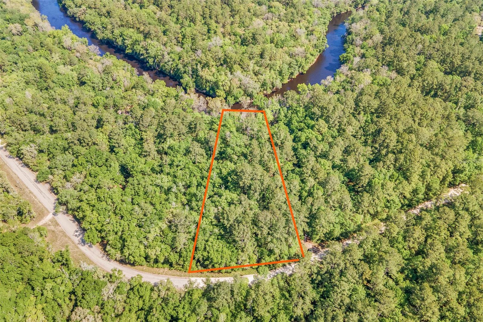 Come kick back and enjoy nature and the sounds of the water over the shoals on this serene 1.65 acre riverfront lot!  Located on the Withlacoochee River in Madison County, Florida, this beautiful lot is wooded with hardwoods and mature pines and on a quiet dirt road. Additional nearby recreational opportunities at Suwannee River State Park, Twin Rivers State Forest & Wildlife Management Area, and Madison Blue Spring State Park--all less than 20 minutes away!  LOT LINES IN AERIALS ARE APPROXIMATE