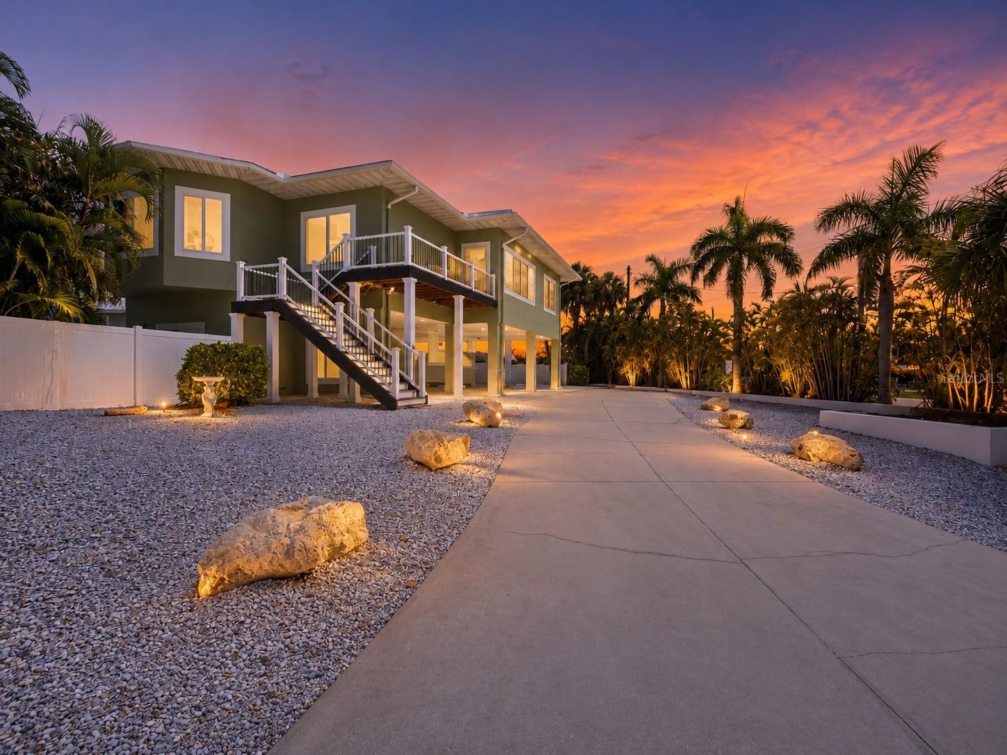 Welcome to your island paradise, just steps from the sugary white sands of Manatee Beach, where gentle Gulf breezes and the laid-back Anna Maria Island lifestyle await. This beautifully maintained elevated concrete block home offers the perfect blend of coastal elegance, modern updates, and exceptional investment potential. The home is situated on an oversized corner lot, providing privacy and peaceful outdoor living. 

Featuring 3 bedrooms, 2 bathrooms, and a private elevator, this spacious home is designed for both comfortable everyday living and effortless vacation enjoyment. The open-concept floor plan is filled with natural light and centers around a large kitchen island, perfectly positioned beneath an oversized window overlooking the sparkling pool and rear deck—ideal for entertaining family and friends or enjoying an alfresco meal!

The generous primary suite is a true retreat, offering a huge walk-in closet and a luxurious ensuite bath complete with a relaxing Jacuzzi soaking tub.

Step outside to your private tropical oasis featuring a newly resurfaced (2022) heated saltwater pool and spa, surrounded by an elegant brick paver deck and professionally landscaped grounds. Enjoy morning coffee on the new front deck (2022) or unwind on the spacious rear deck while soaking in the peaceful island atmosphere and enjoying endless sunsets.

The oversized lower level provides incredible flexibility with ample space for a home gym, game room, workshop, or additional storage. A large driveway and covered carports provide abundant parking for family and guests.  

Major updates include a durable metal roof installed in 2020 offering peace of mind for years to come. 
Inside features tray ceilings, crown molding, updated lighting and fresh paint in beachy neutral tones. 

Located in one of Anna Maria Island's most desirable areas, you'll love being able to stroll to Manatee Beach, restaurants, boutiques, and local entertainment. Hop aboard the free island trolley and explore everything the island has to offer—from historic Pine Avenue to Bridge Street and breathtaking Gulf sunsets.

With weekly rentals permitted, this property offers outstanding flexibility as a full-time residence, vacation getaway, or income-producing investment, allowing rental income to help offset ownership expenses. Whether you're searching for your dream beach home or an exceptional island investment, this coastal retreat truly offers the best of Anna Maria Island living.