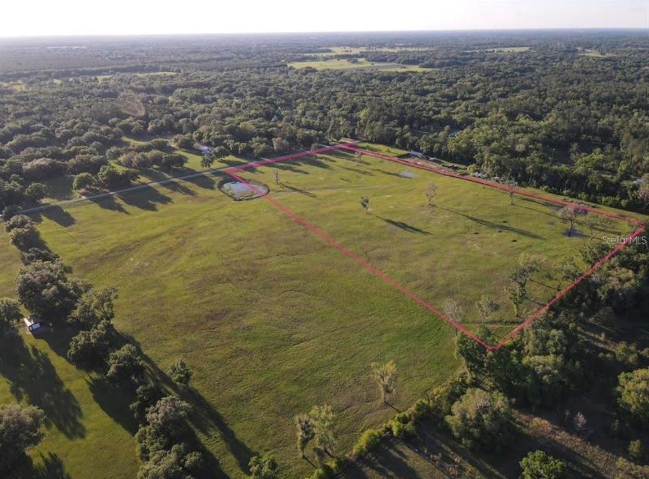 Take a scenic drive through Marion County’s Northwest horse country and experience everything this sought-after equestrian area has to offer. Surrounded by beautiful trees and established horse farms, this 20+ acre property offers a gentle roll and some existing four-board fencing, making it an ideal setting to create your dream farm. Tucked along a quiet, picturesque road with no HOA and backing up to the equestrian community of Paradise Farms. Prime location being only 10 minutes up the road from HITS, 20 minutes from the World Equestrian Center, and within easy reach; just 30 minutes to downtown Ocala and Gainesville, this is an ideal spot to lay down some roots and enjoy the Horse Capital of the World.
