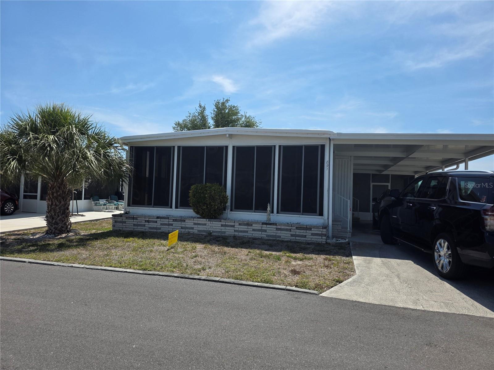 New kitchen with Quartz counter top and new appliances, New TPO roof that sealed also the space between home and carport, new fresh paint, Newt carport and screen room built with 4th wall to meet newly adapted hurricane code.  Great Community has a lot of fun activities and close to all types of restaurants, grocery, top beaches and warm weather.   Seller is licensed real estate broker motivated to sell, exchange 1031, lease with purchase to own, and Seller will pre-pay your HOA fees for the next 3 to 4 years.  No Bank Needed / Rent-to-Own.   Fully Certified Carport and screen Structural Integrity built to exceed the minimum code to have zero hurricane damages.