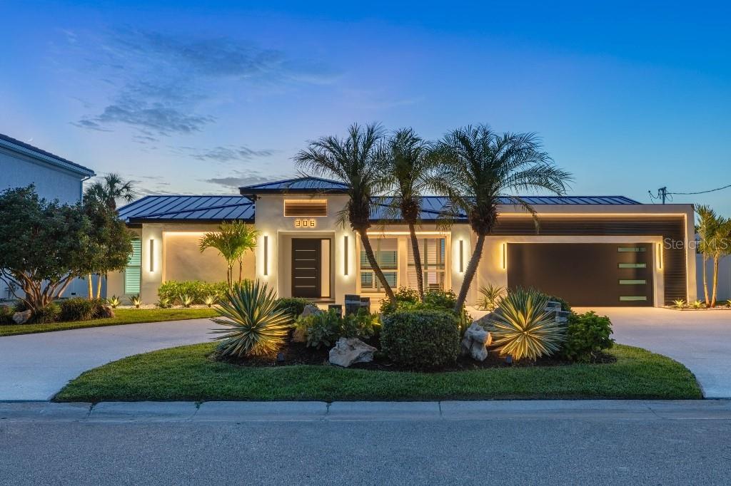 One of Pinellas County's finest fully renovated open-water residences. Ideally positioned on the preferred open-water side of one of the area’s most coveted waterfront streets, this completely reimagined contemporary residence offers panoramic water views, spectacular sunsets, and frequent dolphin sightings. No expense was spared as virtually every interior surface, finish, fixture, and feature was renovated or replaced. Enjoy a designer kitchen with premium LG STUDIO appliances, quartz countertops, dual convection ovens, and an oversized island overlooking the water. The great room features a custom acoustic slat wall, recessed 100” Samsung TV, linear fireplace, premium surround sound, and a spectacular entertaining bar with illuminated shelving and programmable LED lighting. Outside you’ll find a screened pool, brand-new composite dock with 12,000-lb lift, new standing-seam metal roof, new impact windows and doors, and unforgettable waterfront living. Direct boating access to the Intracoastal Waterway and Gulf with no fixed bridges. Nearly every major living area enjoys panoramic open-water views.