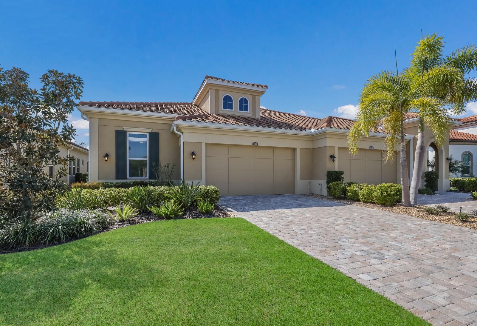 CALATLANTIC CUSTOM BUILT VILLA IN HIGHLY DESIRABLE ARBOR GRANDE! 2 BEDROOM, 2 BATH, PLUS OFFICE AND 2 CAR GARAGE! This custom built villa has many added architectural features, designer finishes, and soaring 12 FOOT CEILINGS. Additional high trayed ceilings can be found in the Primary bedroom, en suite bath, and all of the main living areas. Wall to wall glass sliders with additional transom windows above bring in lots of natural sunlight and enhances the open floorplan of this villa. Neutral colors throughout, as well as rich upgraded solid wood cabinets add to the fresh modern feel of this home. A beautiful gourmet kitchen with built in wall oven, gas cooktop and freestanding hood opens to the sunny dining area. Of course no home is complete without a spacious and private office-perfect for work from home! The many large windows, high ceilings, and 8 FOOT DOORS throughout show off just a few of the added features of this designer villa. Upon entering the leaded glass front door, you can see directly through to a park-like backyard with views of the preserve and pond. The screened lanai is perfect for sitting outdoors anytime of the day or night. Lanai is also pre-plumbed for natural gas, perfect for any outdoor cooking, and easy to add a summer kitchen. This home has generous storage space in the oversized laundry, coat closet, pantry and garage. Nicely appointed bathrooms are bright and contemporary. The walk-in pantry has solid wood shelves-floor to ceiling. Block construction along with a tile roof makes this villa both solid and quiet. The villas are nestled in a resort styled community, with a beautiful CLUBHOUSE, FITNESS CENTER, 2 HEATED POOLS, SPA, PICKLEBALL, BOCCE BALL, and a PRIVATE DOG PARK. This charming home sits directly across the street from all the PRIVATE Villa only amenities. This community has an onsite Manager, several social clubs and interest groups, as well as a very active social calendar of events and planned activities. Arbor Grande is situated next door to BOB GARDNER PARK with 3 resident only gate accesses. This attractive enclave of 122 homes is located in the #1 fastest growing community in the country-LAKEWOOD RANCH. Surrounded by excellent restaurants, shopping, LWR Main Street, and just a 45 minute drive to our world famous beaches makes this an ideal area for your new home. You can enjoy all that resort styled living has to offer with no worry-this community is MAINTENANCE FREE too! This home has been lovingly kept and maintained. Easy to view and move-in ready! See you very soon!
