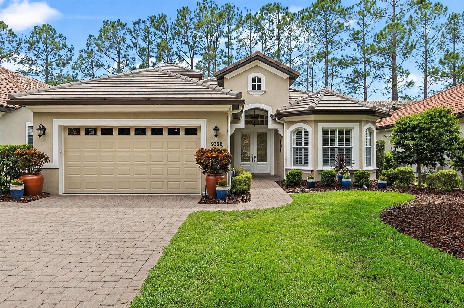 Enjoy a quiet, active lifestyle at Las Colinas in the Mission Inn Resort and Club. Set in the charming town of Howey-in-the-Hills, this community offers an impressive lineup of amenities including multiple dining options, two championship golf courses, tennis and pickleball courts, a spa, skeet and trap facilities, and more. The home is perfectly positioned with tranquil views of a pond and the golf course, and it features a brand-new flat tile roof, an exceptional upgrade that adds value and peace of mind.

Inside, the home has been meticulously maintained and thoughtfully enhanced with upgraded appliances, built-ins in every closet, crown molding, and stylish lighting. Rich wood floors anchor the downstairs bedrooms and den/office, while the spacious primary suite offers walk-in closets, a soaking tub with a separate shower, and dual sinks. The kitchen is designed for both everyday living and entertaining, featuring wood cabinetry, quartz countertops, a farmhouse stainless-steel sink, generous pantry storage, and a sit-down island bar. A large dining room provides ample space for gatherings, and the living area is highlighted by a built-in entertainment center with a gas fireplace, display shelving, space for an enclosed TV, and additional storage.

Upstairs, a flexible bedroom/bonus room with its own air conditioner and half bath is ideal as a media room, office, craft room, or guest retreat. Plantation shutters and window treatments add a polished finish throughout. Step outside to an expansive patio with covered and screened areas designed for year-round enjoyment, plus a large gas fireplace that makes evenings especially inviting. Mature landscaping enhances both privacy and curb appeal.

Beyond the neighborhood, residents also enjoy access to the marina on the Harris Chain of Lakes which is perfect for boating days or bass fishing. This home is truly move-in ready. A Mission Inn Resort and Club membership initiation fee is required; inquire for details.
