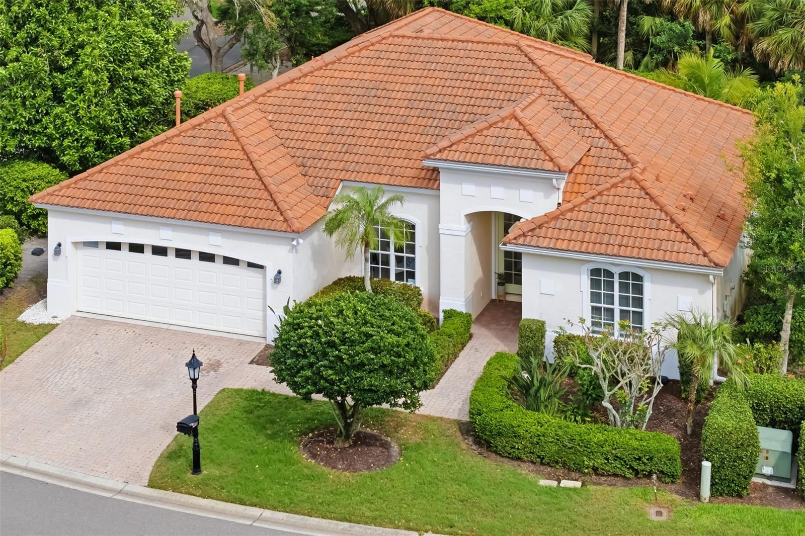 Welcome to the sought-after Monte Verde enclave within the prestigious TPC Prestancia community. Residents enjoy access to 36 holes of championship golf, lush natural landscapes and the privacy of a gated enclave within an Audubon Cooperative Sanctuary. This beautifully maintained four-bedroom, three-bath residence offering 2,406 square feet is perfectly positioned in a 24-hour guarded-gated, maintenance-free community with Flood Zone X for peace of mind. Designed with comfort and functionality in mind, this home features a desirable split floor plan with formal living and dining rooms, complemented by a spacious, light-filled family room that opens effortlessly to the screened lanai through sliding glass doors. The well-appointed kitchen boasts wood cabinetry, Corian countertops and an island for additional prep space, making it ideal for both everyday living and entertaining. Architectural details such as crown molding, double tray ceilings and bay windows enhance the home’s elegance while allowing for abundant natural light throughout. The private owner’s suite and generously sized guest bedrooms provide flexibility for family, guests or a home office. Go outside to enjoy the tranquil Florida lifestyle on your screened lanai or take advantage of the community pool located just across the street, perfect for relaxing without the maintenance. Additional highlights include air conditioning (2022), water heater (2021), tile roof (2002), freshly painted garage floor, quarterly HOA: master $750, Monte Verde $1,235, and aptional TPC golf membership. Just minutes from Siesta Key Beach, dining, and downtown Sarasota, this home offers the perfect blend of luxury, convenience and resort-style living.