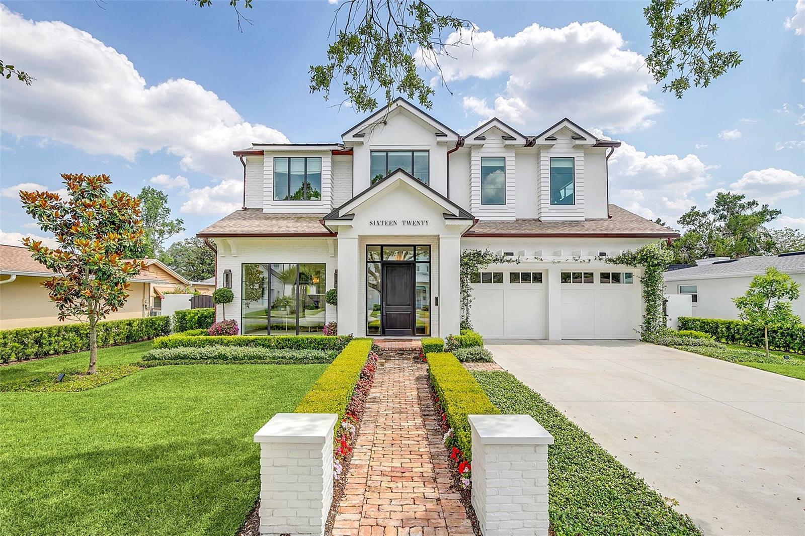 This stunning custom home, completed in 2021, is located among the highly desirable “tree streets” in the heart of Winter Park, and was custom-built by M. Lahr Homes, showcasing exquisite craftsmanship and thoughtful design. With high-end finishes and custom details hand-selected by the owners, this home is sure to check every box.
Designed with both luxury and functionality in mind, the home is equipped with natural gas for the cooktop, water heater, pool heater, grill, and fireplaces, while smart technology enhances modern living with app-controlled kitchen appliances, thermostats, irrigation, pool equipment, and garage doors. Neutral wood flooring, Restoration Hardware lighting, and custom electronic window treatments by The Shade Store add to the home’s understated sophistication. Additional highlights include copper gutters, level 5 finished walls, designer wall coverings, and custom storage throughout.
Offering nearly 4,000 sq. ft. of organic, modern design, the open floorplan blends functionality with timeless elegance. The expansive living and dining areas flow seamlessly into the kitchen, which features Thermador smart appliances, quartz countertops, and a massive island with a stylish open-shelving detail. A hidden walk-in pantry behind the kitchen adds a bar fridge, microwave, and abundant prep space. 
The downstairs Primary Suite is a serene retreat with pool views through a picture window, a spa-like bathroom with a soaking tub and glass-enclosed shower, and an oversized, custom walk-in closet. A second main-level suite with a full bath and walk-in closet is currently used as an office overlooking the front lawn.
Upstairs, a spacious bonus room/living area is surrounded by (3) additional bedrooms, each with walk-in closets, and (2) full bathrooms.
The outdoor living space is an entertainer’s dream. The 8 ft sliding glass doors, with 2 ft. transom windows above, open to a covered lanai with motorized screens, a gas grill, and a fireplace for year-round enjoyment. Beyond the lanai is a meticulously landscaped backyard, fully fenced for privacy, with a heated saltwater pool wrapped in artfully laid out artificial turf and travertine pavers.
Storage is abundant, with a custom-outfitted mudroom and laundry room, an oversized 2-car garage featuring storage shelves, and custom designed closets throughout.
Ideally located, this home offers easy access to downtown Winter Park, Park Avenue, the YMCA, Aloma shopping center, and Whole Foods.