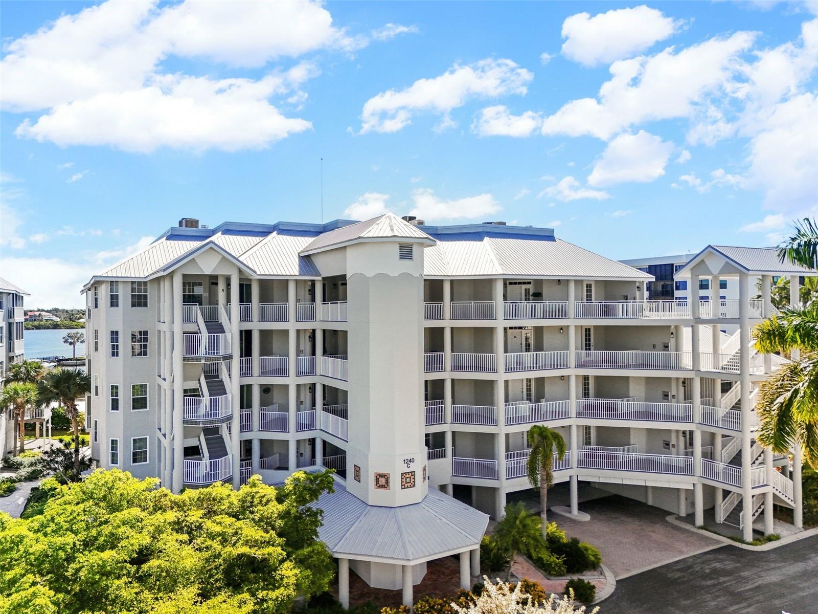 Huge Price Reduction!!! Fourth-floor end unit offering breathtaking views of the intracoastal waterway, featuring three spacious bedrooms and three full ensuite baths. Newly installed luxury vinyl plank flooring graces the entire unit. The expansive glassed lanai boasts recently replaced sliding doors, complete with accordion shutters on the inner doors and impact-resistant glass on the outer ones. The kitchen has been thoughtfully opened up and reconfigured for optimal enjoyment. The living and dining areas are bright and roomy. Dolphin Bay is a sought-after, gated, pet-friendly community with only 50 units, each having its own private underbuilding garage, and well-known for its vibrant atmosphere. Amenities include three Har-Tru tennis courts, an active clubhouse, fitness center, pool and spa, day dock, fishing pier, and kayak access. The complex is well-maintained, with a freshly updated exterior and new elevators in 2024, set amidst beautifully landscaped grounds. Just a short stroll to the world-renowned, white crystal sands of Siesta Key beach. Condo fees at Dolphin Bay are being lowered in 2026.