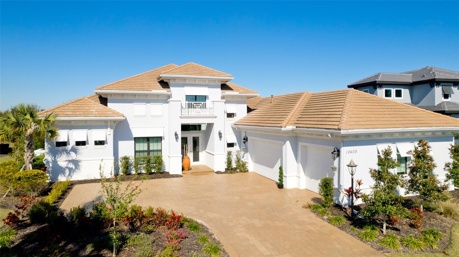 This breathtaking residence is one that truly stands out from the rest. This home exhibits unsurpassed perfection in design and detail. From the moment you enter the double doors, you are welcomed with a spacious and inviting floor plan. Boasting almost 4,000 square feet under air featuring a bright and inviting interior with no detail overlooked. Enjoy the sleek and modern design of every room beginning with the open kitchen, highlighted by the solid wood cabinets, two oversized island spaces, quartz counters, stainless steel appliances, pull out cooling and warming drawers, wine cooler, soft-close drawers and cabinet doors complete the quality finishes in the kitchen. Expansive great room with soaring custom ceilings and crown molding. Truly seamless indoor-outdoor living is offered with pocket sliders in the great room and disappearing sliders in the dining room, both leading to the covered lanai with fireplace. This home has 4 bedrooms all of which have their own full en suite bathrooms. A separate office/den plus an oversized bonus room. Master bedroom is a breathtaking space with high tray ceilings with molding, double doors leading out to your own private pool and spa. Master bathroom is the epitome of luxury with a separate vanities and oversized walk in shower and free standing tub. The expansive outdoor living space includes a custom outdoor kitchen with huge island and built in grill. Enjoy your very own private and custom, heated saltwater pool/spa with water feature overlooking the peaceful and serene landscaped area. Lakewood Ranch has been ranked as one of the best-selling master-planned communities in the nation. Live, work and play in elegance, style and serenity. With an exceptional location, in a sought-after area of Country Club East in Lakewood Ranch, this active, gated neighborhood is a desired choice with the resident only amenity of the Retreat with lap pool and fitness center. Country Club East in Lakewood Ranch is a gated golf community, with several levels of optional Golf and Country Club memberships, including 2 golf courses with world-class practice facilities. Close proximity to great restaurants, golf courses, University Town Center Mall, local shops, Lakewood Ranch Main Street, and a short drive to Downtown Sarasota, St Armands Circle, and our World Famous Siesta Key Beach. Every convenience, just a few miles away! Paradise awaits!