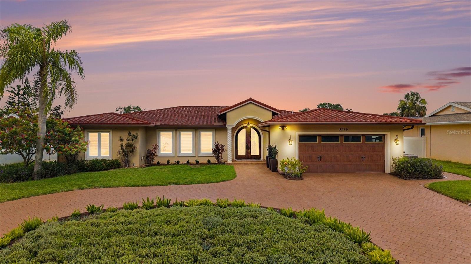 Prepare to be impressed! Welcome to one of the largest and most exceptional homes in highly sought-after Del Oro Groves Estates offering the perfect blend of luxury, space and location. With 3,256 square feet of beautifully reimagined living space, this custom 4-bedroom, 3-bath residence combines exceptional craftsmanship, modern upgrades and a prime location, perfectly positioned on an oversized lot, more than 35 feet above sea level in a non-evacuation zone, yet just half a block from Tampa Bay, a unique combination. Enjoy an active Florida lifestyle, just a short walk to charming downtown Safety Harbor, Del Oro Park, Cooper’s Bayou and the Ream Wilson Trail. Tampa International Airport, St. Petersburg-Clearwater Airport, downtown Tampa, downtown St. Petersburg and award winning Clearwater Beach are all just minutes away. 

Completely reconfigured and remodeled down to the studs with over $600,000 in improvements, this exceptional home features impact-rated windows and sliding glass doors throughout, a stone-coated impact-rated steel roof, updated plumbing and electrical systems and a stunning circular paver driveway. The heart of the home is a chef-inspired kitchen featuring a six-burner gas cooktop island, upgraded vent hood, double wall ovens, built-in refrigerator, abundant custom cabinetry, and spacious side pantries. The open floor plan flows seamlessly into expansive living and entertaining spaces, highlighted by crown molding, custom built-ins, tile flooring throughout and pocket impact sliders that open to the lanai. The luxurious primary suite offers a private retreat complete with a custom walk-in closet, flexible bonus space ideal for a home office, gym, nursery, or hobby room, and a spa-inspired bath featuring dual vanities, a jetted soaking tub, rain shower and custom bench seating.

Designed with versatility in mind, the home’s desirable three-way split floor plan provides privacy for family and guests alike. The in-law suite with separate entryway, offers incredible potential for multigenerational living, extended guest accommodations, or possible rental income. The suite features a cozy gas fireplace, custom built-ins, extensive storage, and solid poured concrete walls in the sitting room for enhanced privacy and durability. Entertainment enthusiasts will appreciate the hidden 4K projector, concealed 120-inch projection screen and in-ceiling surround sound system that transforms the family room into a true home theater experience.

Additional highlights include a tankless natural gas water heater, plantation shutters, programmable thermostats, irrigation system, simply safe security system, dedicated study with dual built-in workstations and custom bookshelves, oversized secondary bedroom that can function as a bonus room, playroom, lounge, or be converted back into two separate bedrooms. Exterior features include a natural gas hook up for outdoor grilling, an updated main sewer line and water service line (2021) and an upgraded paver driveway (2021).

Rarely does a home provide this combination of size, quality, location, and flexibility. Whether you're seeking a luxury family residence, a multigenerational living arrangement, or a property with income-producing potential, this extraordinary home delivers it all.