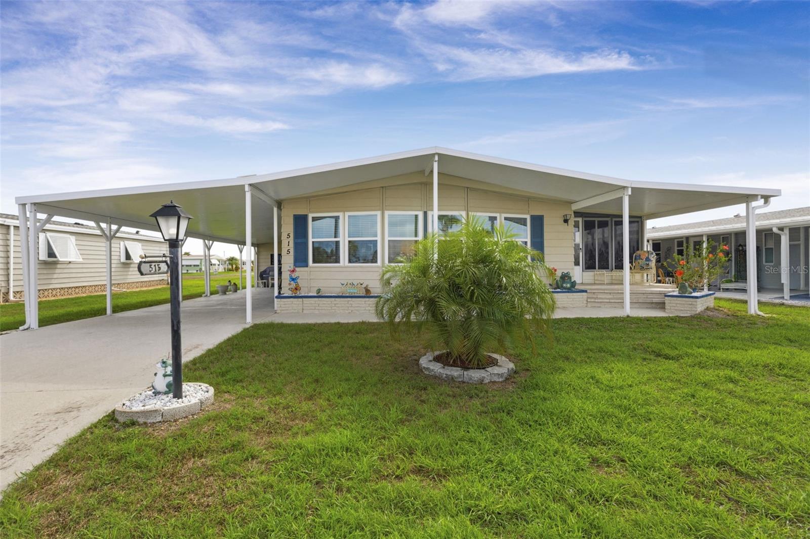 Welcome to this lovely, well-maintained La Casa with stunning lake and sunset views. A new long carport in 2025 leads to a utility room with ample storage. The entry to the home provides a washer, a dryer, and upper cabinets hidden behind double doors. A beautifully remodeled kitchen features an island breakfast bar, appliances, a new refrigerator in 2025, a new dishwasher in 2026, two pantries, and newer cabinets, brightened by a solar tube skylight. A family room/den off the kitchen features a sliding door to an acrylic enclosed Florida room where you can enjoy morning sunrises and evening sunsets. The Florida room also features a door to a rear patio area. The dining room features a large breakfront, and the adjacent living room, with a vaulted ceiling, enjoys glorious lake views and also features a sliding door to the Florida room.  A spacious guest bedroom features a walk-in closet and a door to the tiled guest bathroom with a tub/shower and vanity. The primary bedroom offers ample storage with two double closets, a walk-in, and an additional double closet. The tiled primary bathroom features a double-sink vanity, a walk-in shower, and new faucets. Among the many upgrades are a remodeled Florida room in 2018, new windows and a side door in 2023, and all new flooring in 2022. The home is also located near the Rec Hall and its many amenities.