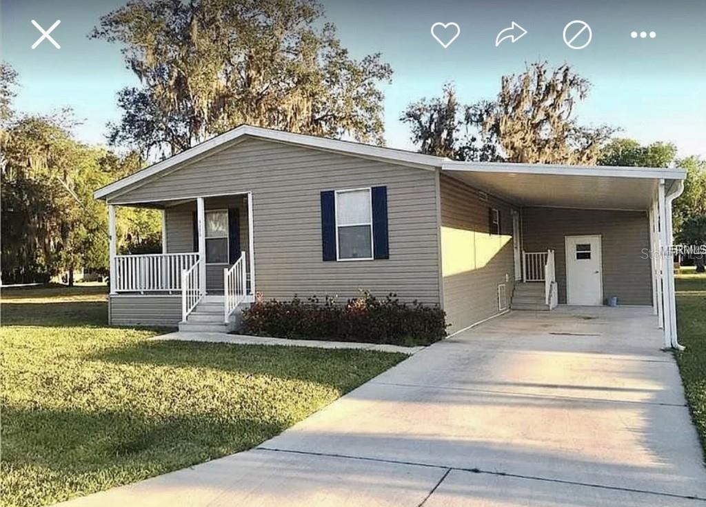 AdorableManufactured Home in a great location! Located in a cute community across from The Villages Brownwood Square that has nightly entertainment, shops, and many restaurants! This 2 bedroom 2 bath home is the perfect full-time or vacation home. Enjoy relaxing on the front porch in this quiet community or going out for a fun night. Topic Isle model by Nobility Homes built in 2013 with vaulted ceilings, crown molding and carpet/vinyl/laminate flooring. Interior laundry hookups and white kitchen appliances. Attached electrically wired Utility Shed (12' x 6') and a Covered Carport (12' x 20') with a driveway that can accommodate 2 cars. Walk-in master closet, master bathroom with walk-in shower, raised vanity, and linen closet. The kitchen has recessed lighting with light cabinets, a refrigerator, an electric range, a microwave hood, stainless steel sinks, and a dishwasher. Cabinet space in the laundry area. The monthly maintenance fee is only $209 Lots of shopping centers nearby, and medical facilities including an ER just 5 minutes away. So come make this new home yours to enjoy life in!