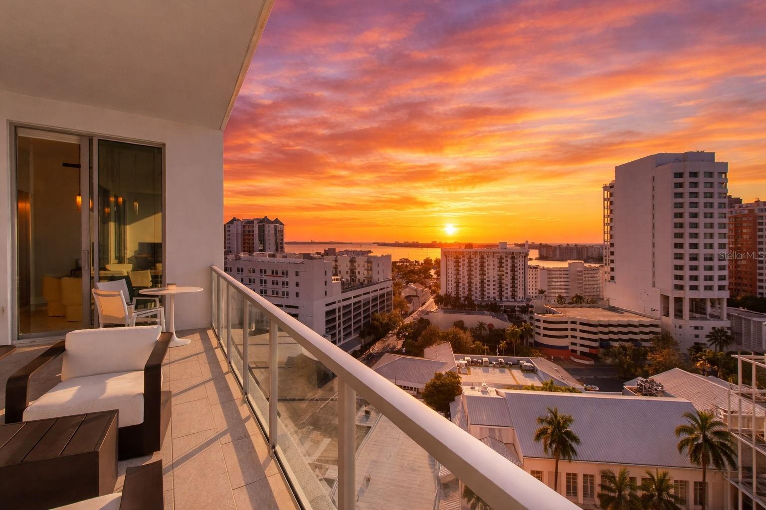 Penthouse level at The Mark Sarasota, featuring complete cosmetic renovation by the owners. Enjoy sweeping west-facing views of Sarasota Bay and downtown Sarasota from this refined residence offering 2,485 square feet under air plus 342 square feet of terrace space, for a total of 2,827 square feet. The thoughtfully designed split-bedroom floor plan includes three en-suite bedrooms, a den/office, three full baths and one-half bath, with a private primary suite wing. Timeless in design, the gourmet kitchen is appointed with Nolte European cabinetry, JennAir stainless steel appliances, upgraded induction range, quartz countertops with a new 6-cm waterfall island and a modern tile backsplash, ideal for entertaining. Open-concept living and dining areas feature soaring 11-foot ceilings, floor-to-ceiling glass and large-format porcelain tile flooring, creating a bright, architecturally refined interior. An expansive west-facing terrace extends the living space outdoors with a built-in grill and beverage refrigerator, ideal for sunset dining. The primary suite is a luxurious retreat with two walk-in closets and a spa-inspired bath offering an oversized double vanity, quartz countertops, walk-in shower and soaking tub. Two guest en suites include generous closets, while the den off the foyer serves as an ideal home office. New Legno European white oak oil-waxed floors enhance all bedrooms. Additional highlights include all-new lighting fixtures throughout, new full-length mirrors in all bedrooms, new bath glass shelving and hardware, a large laundry room with utility sink and new floor-to-ceiling custom cabinetry, a new smart Lutron system controlling lighting and shades, and a new custom wet bar with Sub-Zero beverage drawers and a Scotsman ice maker. Enjoy abundant natural light and glowing Sarasota Bay sunsets overlooking the tropical pool deck. Two deeded parking spaces, with EV charging, plus a climate-controlled storage unit just a short distance from the residence. The fifth-floor amenity level offers a resort-style heated saltwater pool and spa, fire pit, lounge areas, grilling pavilion, bar, club room with catering kitchen, billiards, newsroom, and a premier fitness center with yoga and spin studio. In the heart of downtown Sarasota, enjoy walkable access to top-rated restaurants, Saturday Farmers Market, galleries, salons, cultural venues, Marina Jack and Lido Beach just over the Ringling Bridge. With 24-hour concierge service, secure access, on-site management and pet-friendly living, this residence delivers effortless luxury and coastal sophistication at one of Sarasota’s desired addresses.