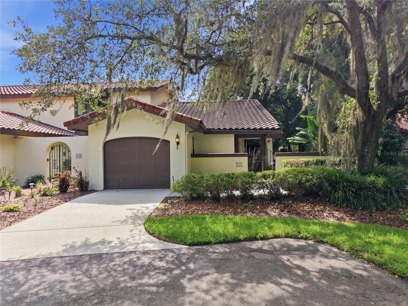 Welcome home to this charming 2-bedroom, 2-bathroom residence nestled in a peaceful community surrounded by mature trees and lush greenery.

As you arrive, you'll be greeted by a private gated courtyard entrance, creating a warm and inviting first impression. The home also features a one-car garage and additional driveway parking for convenience.

Step inside to find a spacious living room filled with natural light at the heart of the home. Enjoy both a formal dining area and a cozy breakfast nook, giving you plenty of options for entertaining or everyday living. The kitchen offers matching appliances, ample counter space, and room to cook and gather.

The large primary suite is a relaxing retreat with direct access to the screened patio through sliding glass doors, a walk-in closet, and a private bathroom featuring dual sinks, a soaking tub, and a separate walk-in shower. The second bedroom and bathroom are located on the opposite side of the home, providing added privacy for guests or family members.

Outside, unwind on the screened-in patio overlooking a peaceful tree-lined backyard, complete with a bench perfect for enjoying your morning coffee or evening relaxation.

Don't miss this opportunity to make this inviting home yours. Contact us today for more information or to schedule a showing!