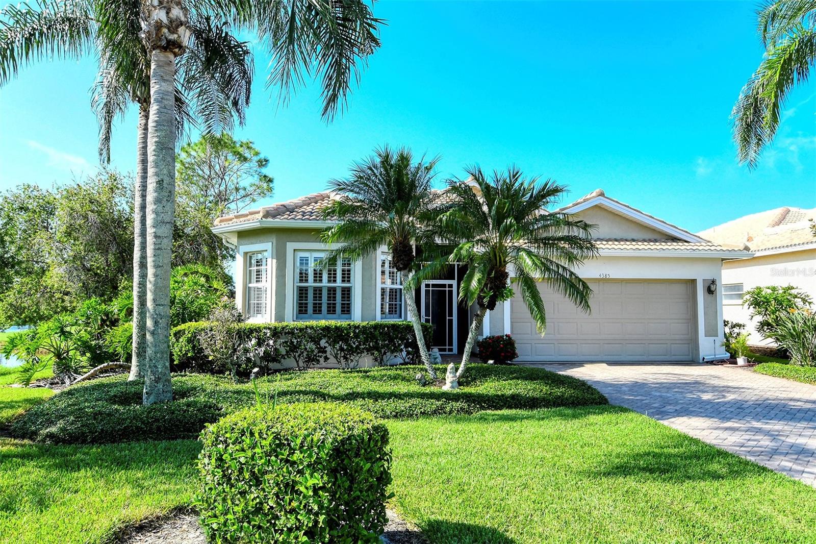 You will not want to miss this gorgeous property! Nestled at the back of a private cul-de-sac in Heritage Oaks Golf & Country Club, this rarely available Doral model Patio Home is being sold Turn-Key Furnished and features phenomenal golf and water views, a large lanai with heated swimming pool and spa, and a brand new tile roof (2023). With 2 bedrooms, 2 bathrooms, and a den/study, the property features almost 1,800 square feet of living space and more than enough room to host friends and family. The property features many spectacular updates including: double tray ceilings with crown molding, granite countertops and stainless steel appliances in the kitchen, beautiful laminate wood flooring in the den and guest bedroom, luxurious plantation shutters on all windows, and a powered awning on the lanai to provide a plentiful amount of shade during those hot Florida summer days. In addition, a brand new washer and dryer were installed in 2023. The open floor plan layout is great for entertaining, as the kitchen features open sight lines directly to the rear facing lanai and pool area. The split bedroom layout is also very functional, as it gives guests and family total privacy. Spend mornings or evenings on the large private lanai taking in the wonderful views and the abundance of wildlife that call this certified Audubon Neighborhood their home. Heritage Oaks is known for its pristine 18-hole golf course, har-tru tennis courts, fitness center, 24-hour security, an impressive clubhouse with 2 restaurants including the sensational 19th Hole Lounge, 5 heated swimming pools, and a calendar of events packed with activities. Come take a look at this amazing property, as it will not last long!