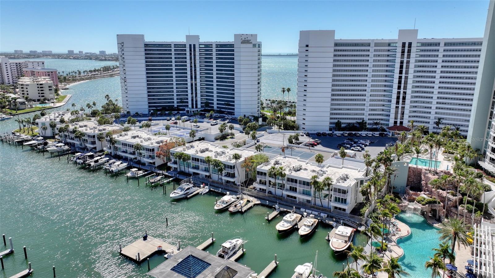 Enjoy the best of waterfront and city living in this rare bayfront townhome, perfectly positioned
in one of Sarasota’s most sought-after locations. This three-level residence offers stunning
marina views, a private boat slip, and direct access to Sarasota Bay.
Inside, an elegant spiral staircase connects the open living spaces. The main level features warm
red oak flooring, a custom bar with an India Redwood countertop, and a striking reclaimed
Florida cypress front. The kitchen is designed for both style and function, with granite counters,
sleek wood cabinetry, a decorative tile backsplash, and a dedicated coffee station. A balcony off
the living area offers a front-row seat to sailboats, pelicans, and even the occasional dolphin or
manatee.
Upstairs, two en-suite bedrooms each have their own balcony and impact-resistant sliding doors.
A bonus office/den space and laundry nook add convenience. The lower level provides a
spacious flex area for storage or additional bonus space, plus a bathroom, a kitchenette, and sliding
glass doors that open to a deck overlooking the marina. The attached two-car garage completes
the layout.
Step outside to your deeded boat slip down the boardwalk for effortless bay access. As part of the Condo on the Bay
community, enjoy resort-style amenities including two pools, saunas, gyms, pickleball and tennis
courts. Right next door, The Bay offers walking trails, kayaking, outdoor fitness, live music, and
movies, while the vibrant downtown and Rosemary District are just minutes away.
A whole-house water filtration system and central vacuum add modern convenience to this
exceptional home. Don’t miss the chance to experience bayfront living at its finest.