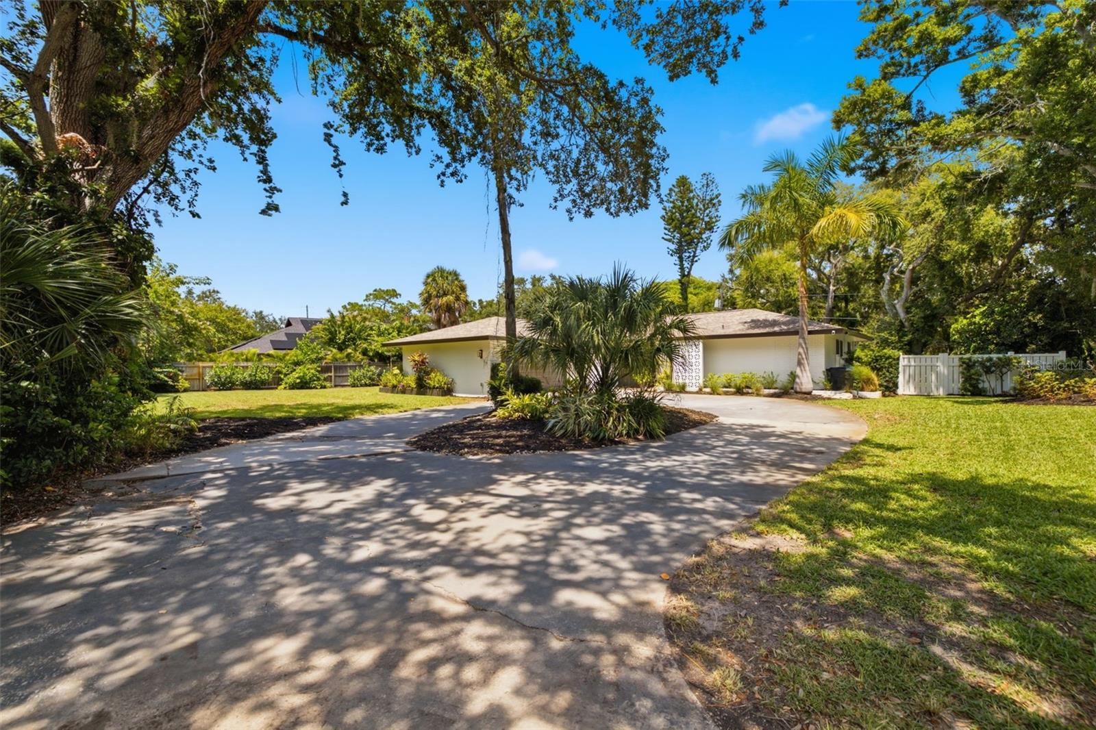 Striking mid-century modern 2-bedroom, 2-bathroom, 2-car garage pool home tucked away in the highly desirable Pinellas Point neighborhood, offering the perfect blend of timeless character, privacy, and convenience to everything that makes St. Petersburg so special. Nestled on a peaceful cul-de-sac just blocks from the waterfront, boat ramp, and park, this home feels like a private retreat while keeping you minutes from Downtown St. Petersburg, the Gulf beaches, and I-275. Inside, the open split-bedroom floor plan showcases the home's classic mid-century appeal with a beautiful combination of warm wood and terrazzo flooring. Step outside to your fully fenced backyard oasis featuring an oversized screened pool, covered patio, and plenty of space for relaxing or entertaining. Need extra flexibility? A detached, air-conditioned shed provides the perfect space for a home office, creative studio, craft room, gym, or workshop. You'll love the unbeatable location with Paradeco Coffee Roasters, Maximo Park's waterfront trails and disc golf course, nearby marinas, high-and-dry boat storage, public boat ramps, local restaurants, and everyday conveniences all just minutes away. For added peace of mind, this home has been thoughtfully updated with a newer roof, HVAC system, ductwork, attic insulation, plumbing supply lines, electrical panel, and more, allowing you to enjoy the charm of a classic mid-century home with the confidence of major modern improvements. This is a rare opportunity to own a true mid-century modern retreat in one of St. Petersburg's most beloved neighborhoods.