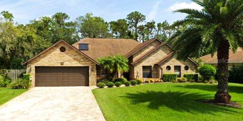 This lovely spacious home sits on almost a half-acre lot and is surrounded by mature landscaping and trees and bushes and greenery offering you a private oasis of peaceful space and serenity in one of the most sought-after communities in Ormond Beach.  Breakaway Trails is well-established and offers numerous amenities to their homeowners.  The HOA and Leland Property Management are knowledgeable and helpful in every way.  Their amenities include a lovely clubhouse with a pool, basketball courts, pickleball courts, a playground, a dog park and more.
With 4 bedrooms and 2-1/2 bathrooms, the layout and flexibility of space is never-ending.  The Master Bedroom (freshly painted) is huge and encompasses 2 walk-in closets and a large en-suite bathroom with a garden tub, separate shower and a tremendous amount of storage space.  The toilet is a separate and private area of the bathroom.  The 2nd and 3rd bedrooms are large and the 4th bedroom has been used as a den/office as it is a bit smaller.  The open floor plan is great for entertaining family and friends inside and the Florida Room (enclosed) and the tiled Patio allows the same vibe as they are both almost the length of the entire house.  The Florida Room is large enough to create an additional bedroom or office or play room.  It is totally surrounded by windows looking out to the large screened patio and the luscious expansive back yard.  Relax at evening time in your living room while sipping a glass of wine with comforting warmth from your wood-burning fireplace surrounded by brick stone.  Hang your Christmas stocking on the fireplace mantle.  Place your favorite treasures on the mantle to admire every day.  There are 3 sets of French Doors in this home, 2 lead from the Living Room to the Florida Room (and Patio) and 1 set in the Master Bedroom also leads outside.   Host dinner parties for your family in the formal Dining Room while enjoying the sunlight streaming in through the Bay Window and warming everyone at your table.  The Kitchen provides a lot of cabinets for storage and a built-in pantry with ample room for more than one chef.  The Kitchen cabinets (and bathrooms) have all been upgraded with pull-out drawers by Shelf Genie.  You will love these!  The Kitchen then leads to a cozy breakfast nook again surrounded by windows.
This traditional brick home features a new Roof, new Fascia, Soffits and Gutters, a new Hurricane-rated (5) Garage Door, a new Refrigerator, Dishwasher, and toilets & faucets.  Most importantly, living in Florida, the seller has purchased a WHOLE HOUSE GENERAC GENERATOR with 2 huge propane tanks for fuel to keep you safe and at home.  Rest assured you will be safe and secure during our storm season.  You deserve to experience Florida-living in a community that is convenient to highways, shopping, restaurants, churches, A-rated schools and all the beaches along the Atlantic Coast.  Daytona is a mere 20 minutes away!  This awesome private oasis is ready and waiting for you to call it "HOME."