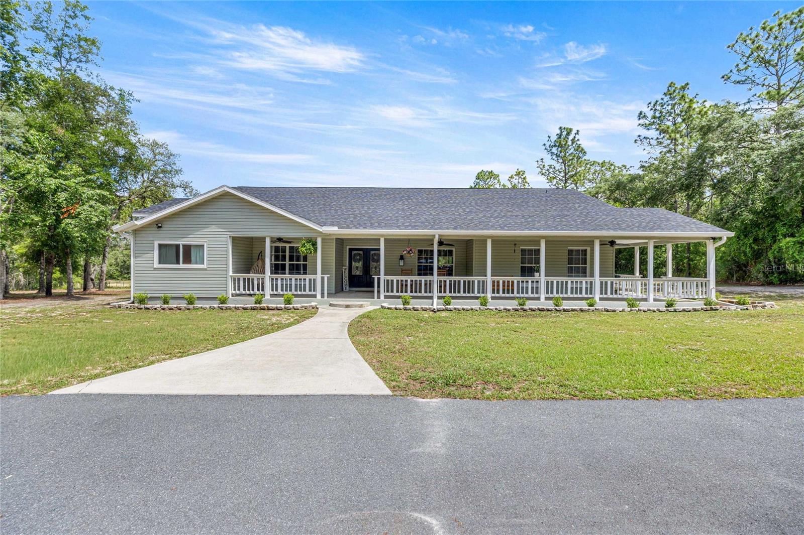 Beautiful ranch style home situated on 4.8 +/- acres, fully fenced with an electric gate. This 3-bedroom, 2-bath home with an office features a charming wraparound porch, spacious layout, and peaceful private lot on a quiet dead-end road. 

Recent updates include a new roof (2023), new A/C (2023), new well (2026), driveway repaved (2023), updated bathrooms, and new paint interior and exterior . 

This home features a spacious kitchen with ample counter space, and several sliding glass doors that fill the space with natural light while offering peaceful backyard views.

Enjoy outdoor living with an above-ground pool and plenty of space for animals, toys, or recreation. The detached garage includes an upstairs loft and first floor bathroom with incredible potential for a guest space, workshop, studio, or extra storage, just waiting for your finishing touches. A rare opportunity to enjoy privacy and country living while still being conveniently located!