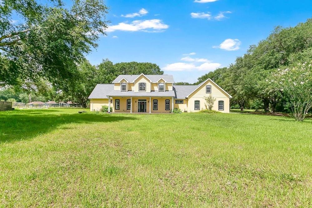 Beautiful serene living on Lake Bryant! 5 bedroom 4 1/2 bath beautiful home surrounded by mature oaks, fruit trees on an expansive 14.53 acre canvas of natural beauty. This spacious farmhouse features a large open concept living area and a second living/family room. The large primary is located downstairs with a beautiful ensuite bathroom with oversized shower and duel sinks. The other two bedrooms on the first floor also have en suites. Beautiful kitchen with granite countertops, custom cabinets and stainless appliances. There is a large bonus room above the garage that is not included in the square footage. Roof December 2024, new A/C, new whole home water filtration system, Tesla charger and home has been prepped for solar. The land is equipped with 5 underground water lines running through the yard ready for you paddocks or nursery. This peaceful country estate is perfect for your primary, mini farm, or multigenerational family. Plenty of room for a barn or other structure. 7 acres are tropical wetland and 7 acres are high and dry. 300 ft of lake frontage on spring fed Lake Bryant. Most of the neighbors on this lake have docks. Public boat ramp 3 minutes away. The property is nestled in the Ocala National Forest. Enjoy sitting on your large front porch with visits from peacocks and sandhill cranes. Abundant deer population and ample turkey flocks in the wooded portion of the property. Schedule your showing today to make this beautiful farmhouse yours today!
