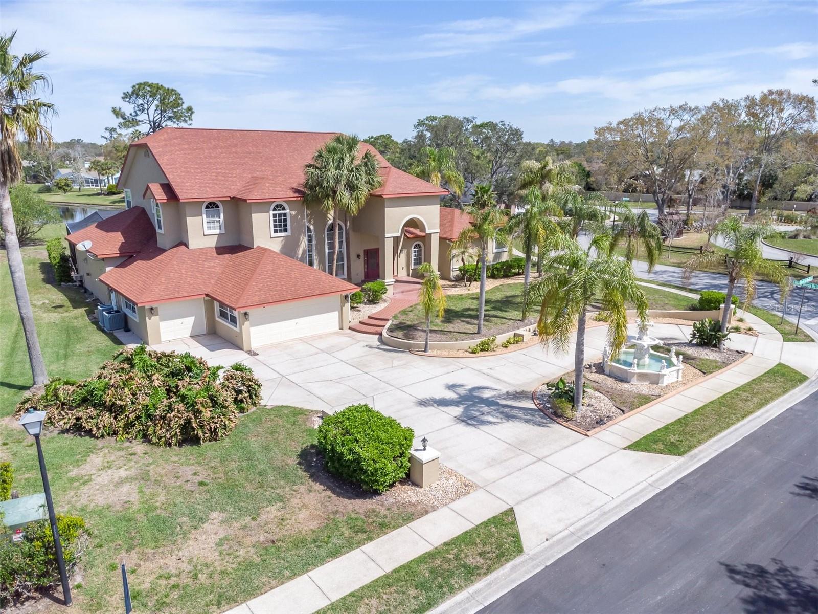 Welcome to this exceptional estate located in the gated community of Lake in the Woods, offering 4 bedrooms and 2.5 bathrooms in the main house. This spacious home features an additional private 1 bedroom and 1 full bathroom just off the pool, which would make an ideal in-law suite, guest retreat, or convenient pool bath setup; a 3-car garage; and over 5,400 square feet of luxurious living space. Situated on a beautifully landscaped 0.74-acre lakefront lot, this home combines elegance, comfort, and resort-style living. The home has been thoughtfully updated with a new roof in 2023, new pool enclosure in 2024, and upgraded air conditioning systems in 2022 and 2018 for peace of mind and year-round comfort. A grand entrance featuring double-leafed-glass front doors opens to soaring ceilings, a dazzling crystal chandelier, and a carved marble gas fireplace, creating an impressive first impression. The gourmet kitchen is designed for both everyday living and entertaining, featuring high-end appliances, generous counter space, a second fireplace, a custom wood bar with a wine cellar, and beautiful views overlooking the pool and lake. The spacious first-floor primary suite offers a private retreat complete with a spa-inspired bathroom featuring a towel warmer, stand-up shower, sauna tub, and a second washer and dryer hookup in the primary bedroom for added convenience. Outdoor living is where this property truly shines. The expansive 30x63 pool deck provides ample room for entertaining, relaxing, and enjoying peaceful lake views. The outdoor kitchen includes a built-in Thermador grill, a beer refrigerator, and an outdoor shower. Lake in the Woods is known for its serene setting and outstanding amenities, including 24/7 staffed gated security, tennis courts, pickleball court, dog park, fishing lake, island pavilion, and scenic walking trails. Conveniently located near the Gulf beaches, shopping, dining, hospitals, and major highways, this home offers the perfect balance of privacy and accessibility.