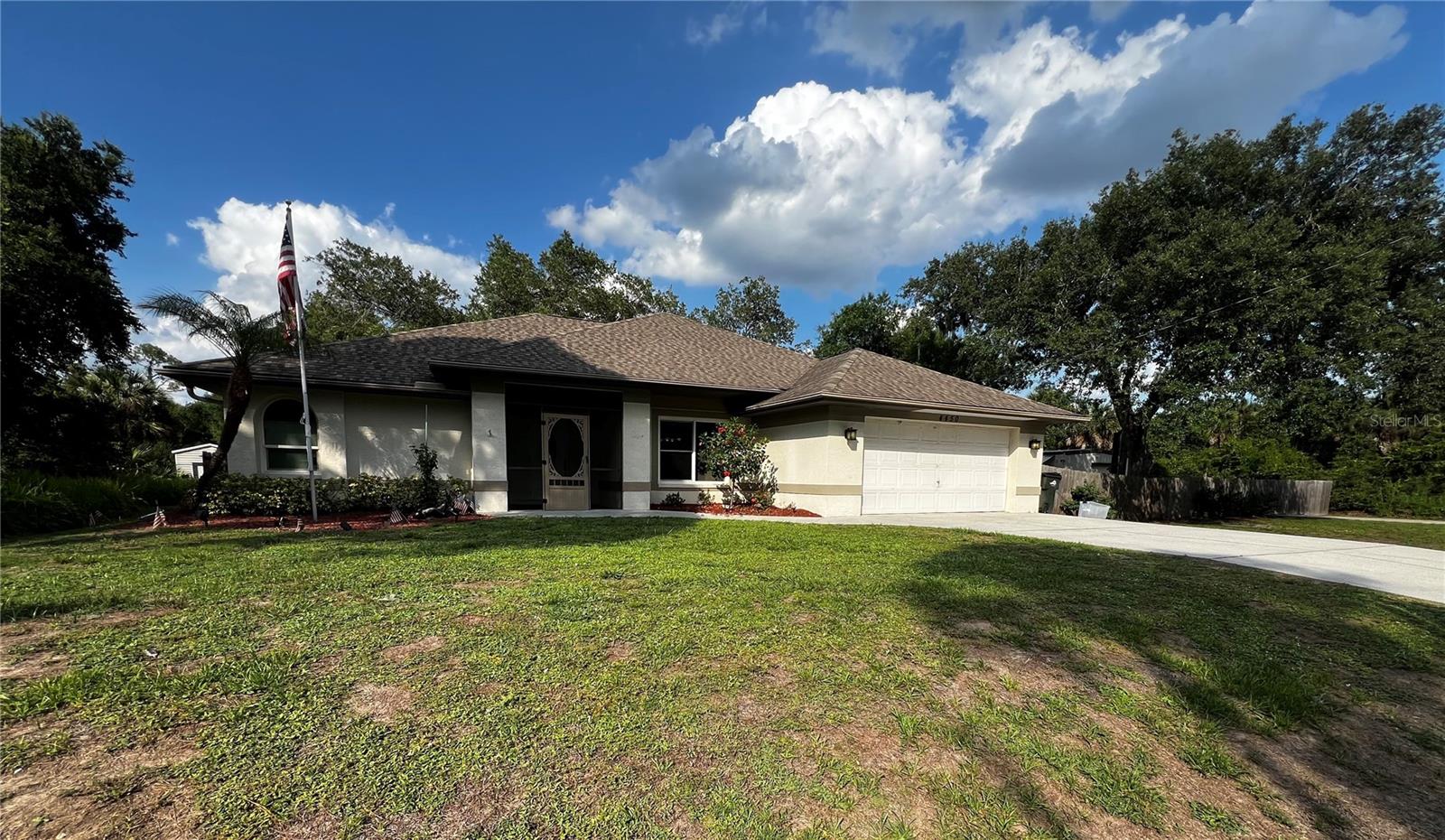 Beautifully maintained home situated in the heart of North Port on a rarely available acre of land! Offering nearly 2,000 square feet of living space, this exceptional property combines privacy, functionality, and convenience. The fully fenced and gated property features access from both sides, providing added security and flexibility. Car enthusiasts, hobbyists, or those needing extra workspace will appreciate the detached outbuilding, ideal for a workshop, storage, or tinkering with projects. In addition, the property includes two separate storage sheds, providing an abundance of space for tools, equipment, seasonal items, and recreational gear—creating the Florida equivalent of a basement, a feature many northern buyers will appreciate. Inside, the home has been freshly painted and is truly move-in ready, featuring tile flooring throughout for easy maintenance, impact windows for added peace of mind, and a newer HVAC system. A whole-house Generac propane generator ensures you'll never be without power during unexpected outages. Situated high and dry in a preferred flood zone where most lenders do not require flood insurance, this property offers additional savings and peace of mind. Ideally located near world-famous Gulf beaches, shopping, dining, the new Costco, and the Atlanta Braves Spring Training facility, this one-of-a-kind property offers the perfect blend of space, comfort, and location. Schedule your private showing today—opportunities like this are rare and won't last long!